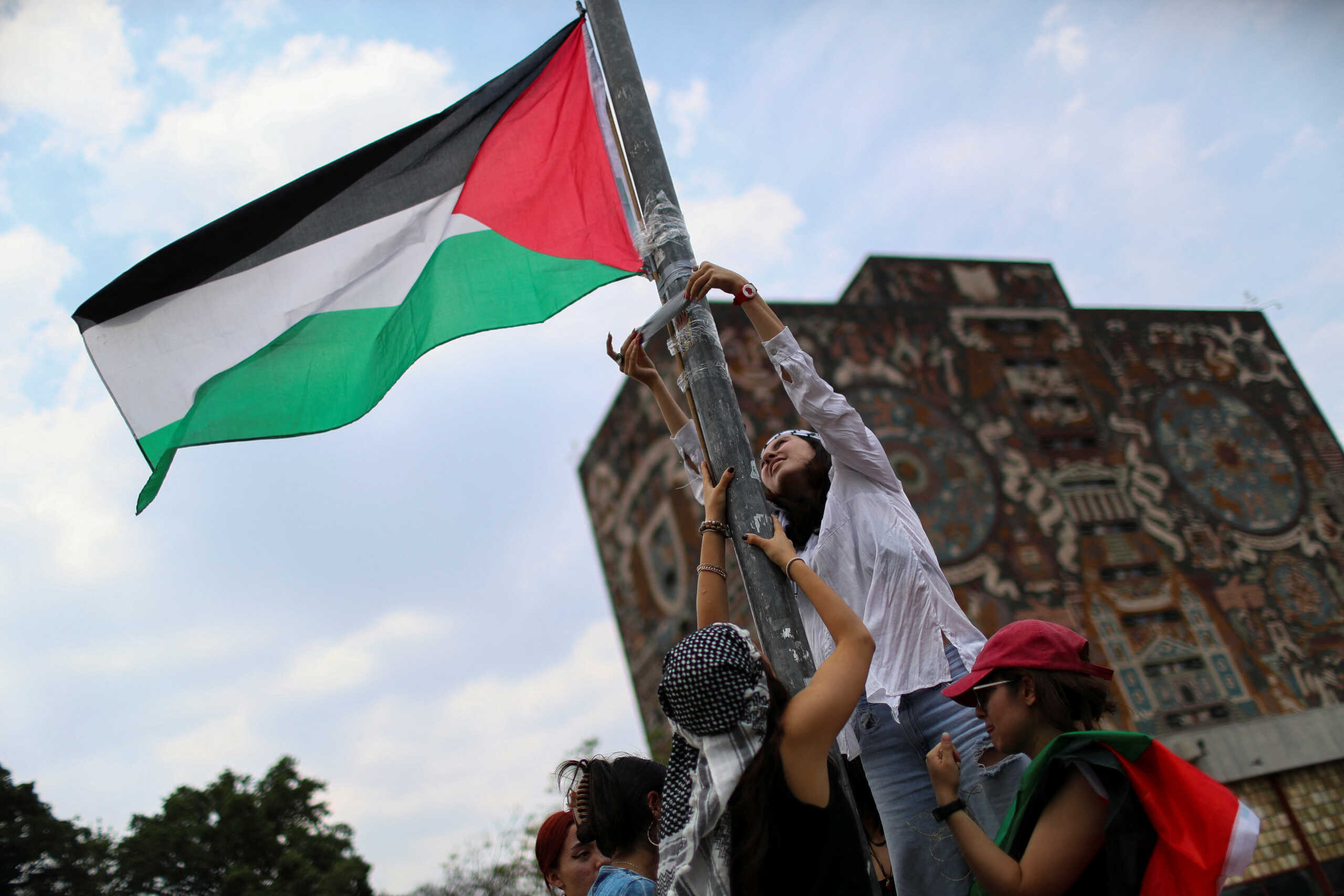 Students attach a Palestinian flag to a post, during a campus protest at the National Autonomous University of Mexico (UNAM) in support of Palestinians, and to break academic, political and economic relations with Israel, in Mexico City, Mexico. May 2, 2024. REUTERS