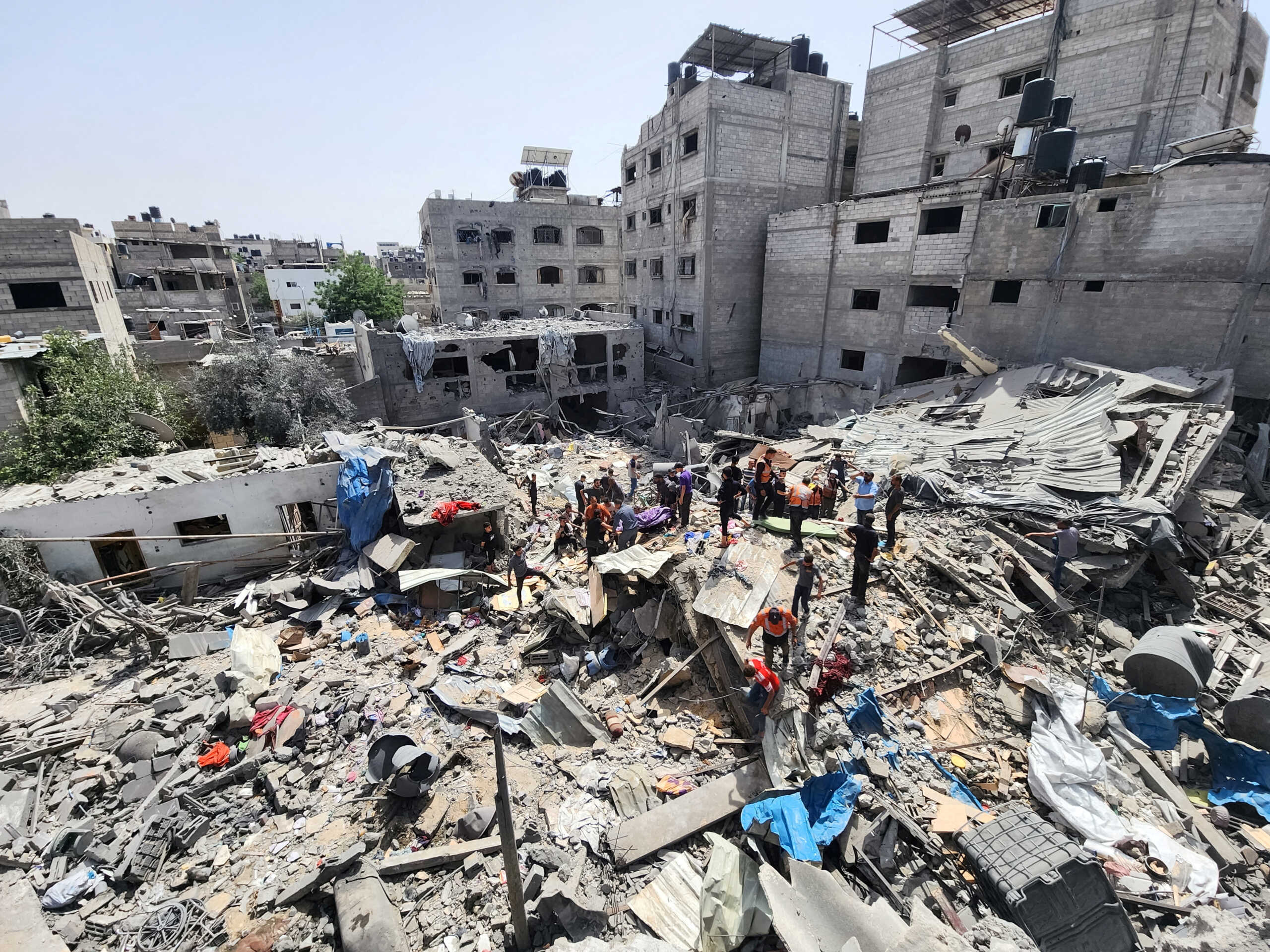 Palestinians carry the body of a person killed in an Israeli strike on a house, amid the ongoing conflict between Israel and the Palestinian Islamist group Hamas, in Jabalia refugee camp in the northern Gaza Strip, May 18, 2024. REUTERS