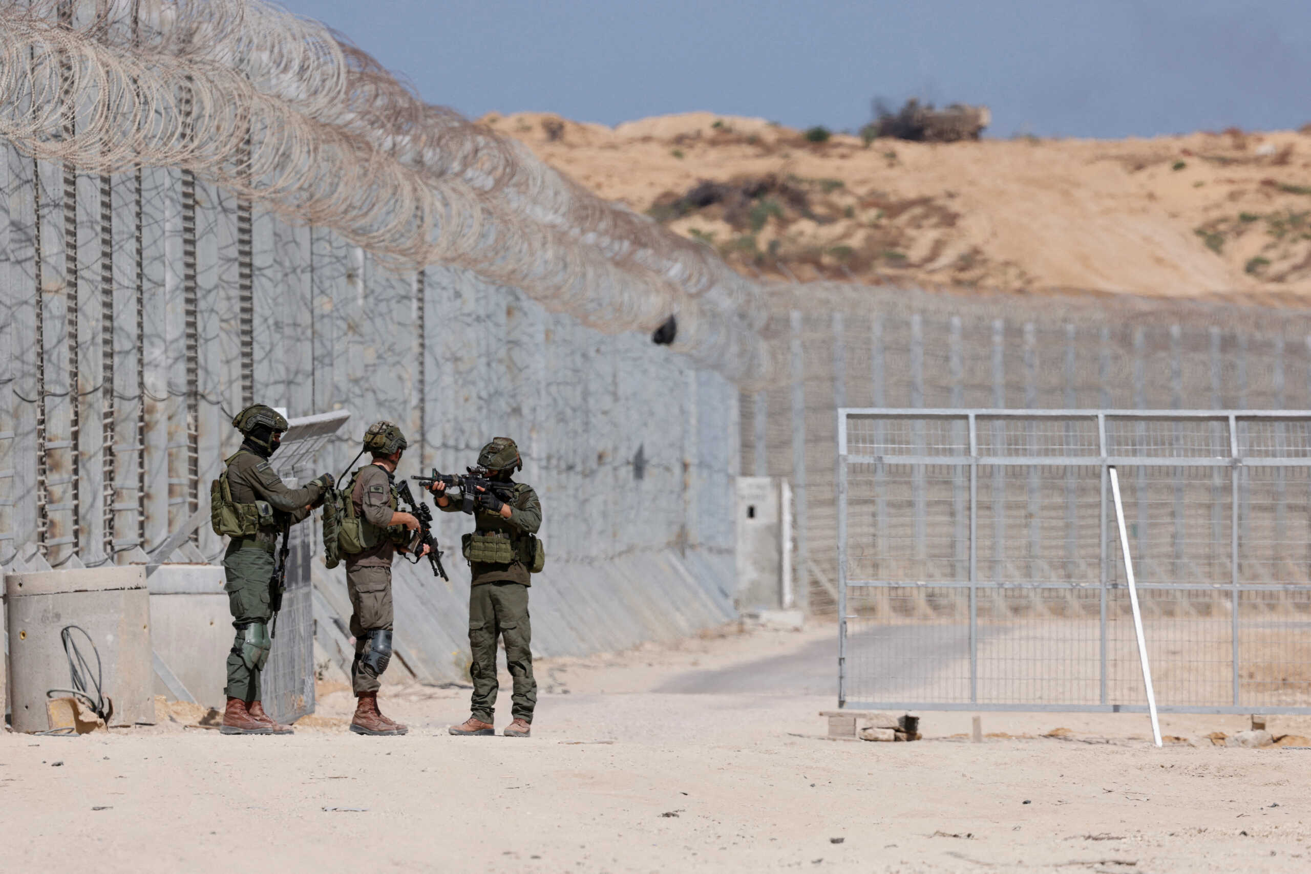 Israeli soldiers stand guard, as an Israeli armoured personnel carrier manoeuvres inside the Gaza Strip, amid the ongoing conflict between Israel and the Palestinian Islamist group Hamas, at Erez Crossing in southern Israel, May 5, 2024. REUTERS