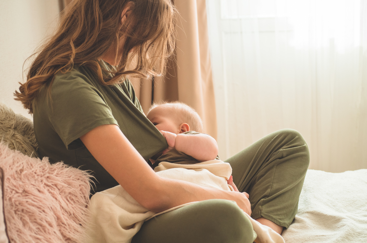 The concept of breastfeeding. Portrait of mom and breastfeeding baby.
