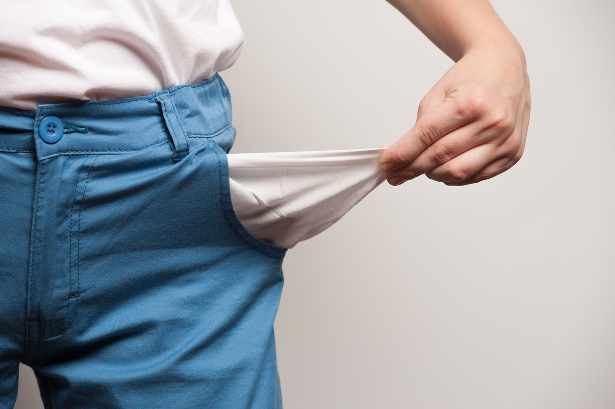 Demonstration of empty pockets in pants. Symbolic illustration of financial problems or bankruptcy, poverty, poor