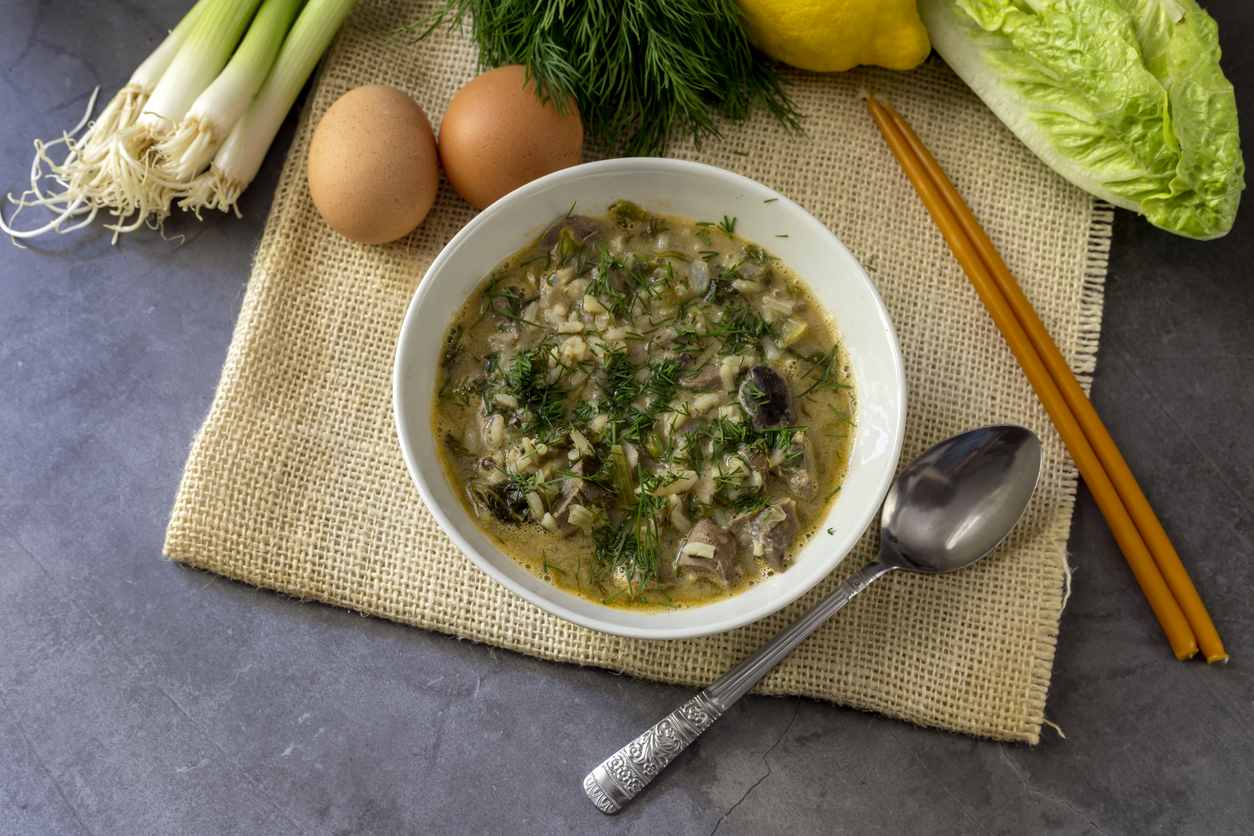 The easter composition. National Greek soup Magiritsa in a bowl, which is prepared once a year on Easter, on a wooden table close-up