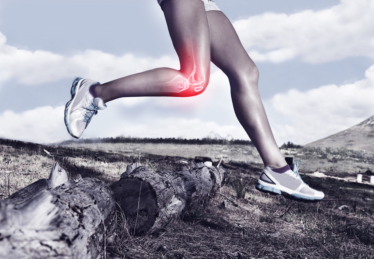 A cropped view of a female jogger on a trail experiencing joint inflammation