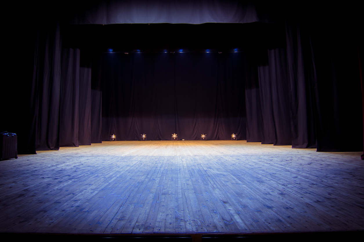 An empty stage of the theater, lit by spotlights before the performanceAn empty stage of the theater, lit by spotlights before the performance