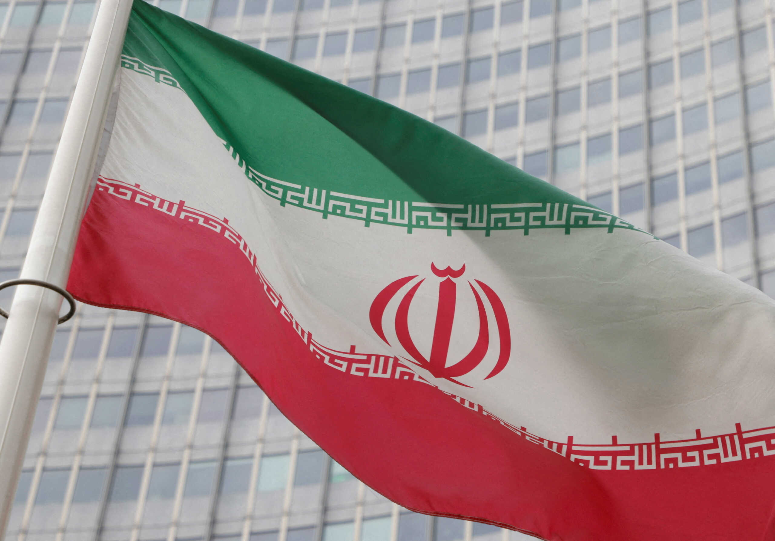 FILE PHOTO: The Iranian flag flutters outside the International Atomic Energy Agency (IAEA) headquarters in Vienna, Austria, March 6, 2023. REUTERS