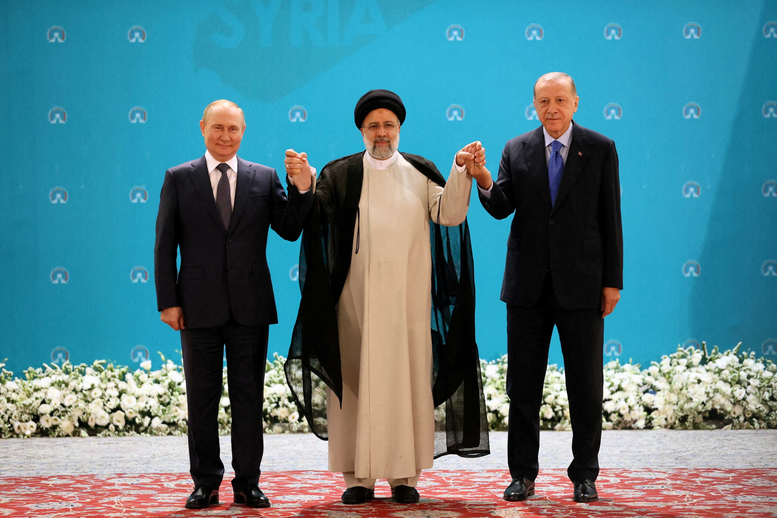 FILE PHOTO: Russian President Vladimir Putin, Iranian President Ebrahim Raisi and Turkish President Tayyip Erdogan pose for a picture before a meeting of leaders from the three guarantor states of the Astana process, designed to find a peace settlement in Syria crisis, in Tehran, Iran July 19, 2022. Sputnik