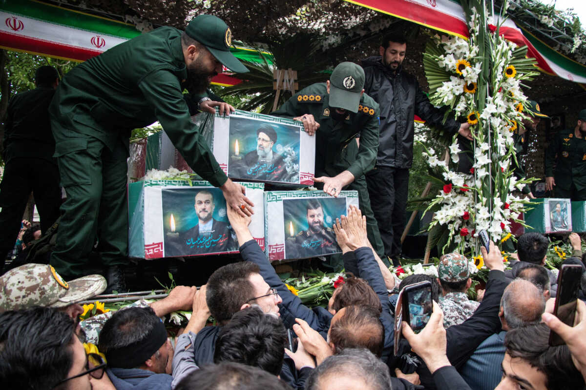 A picture of the late Iranian President Ebrahim Raisi is seen on his coffin during a funeral ceremony held in Tabriz, East Azerbaijan Province, Iran, May 21, 2024. Stringer