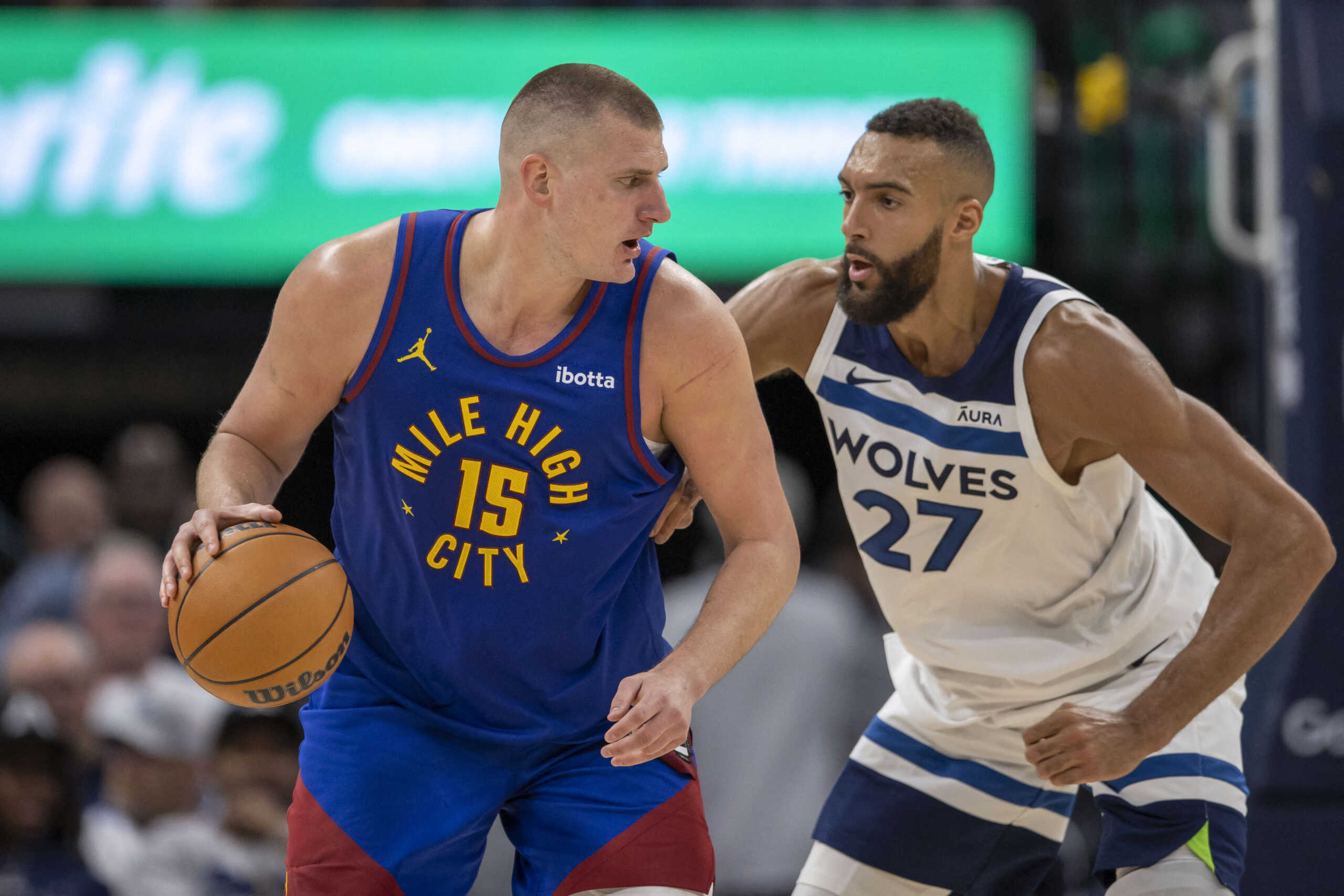 May 10, 2024; Minneapolis, Minnesota, USA; Denver Nuggets center Nikola Jokic (15) controls the ball as Minnesota Timberwolves center Rudy Gobert (27) defends in the second half during game three of the second round for the 2024 NBA playoffs at Target Center. Mandatory Credit: Jesse Johnson-USA TODAY Sports