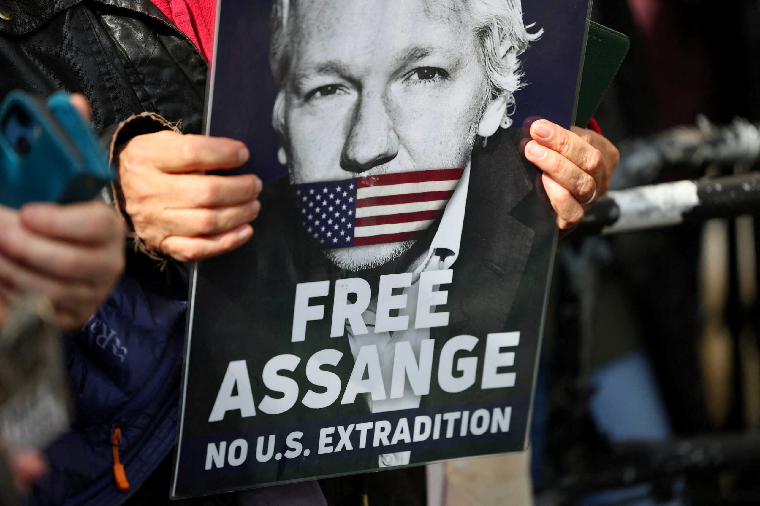 FILE PHOTO: A supporter of WikiLeaks founder Julian Assange holds a sign, on the day the High Court is set to rule on whether Julian Assange can appeal against extradition from Britain to the United States, in London, Britain, March 26, 2024. REUTERS