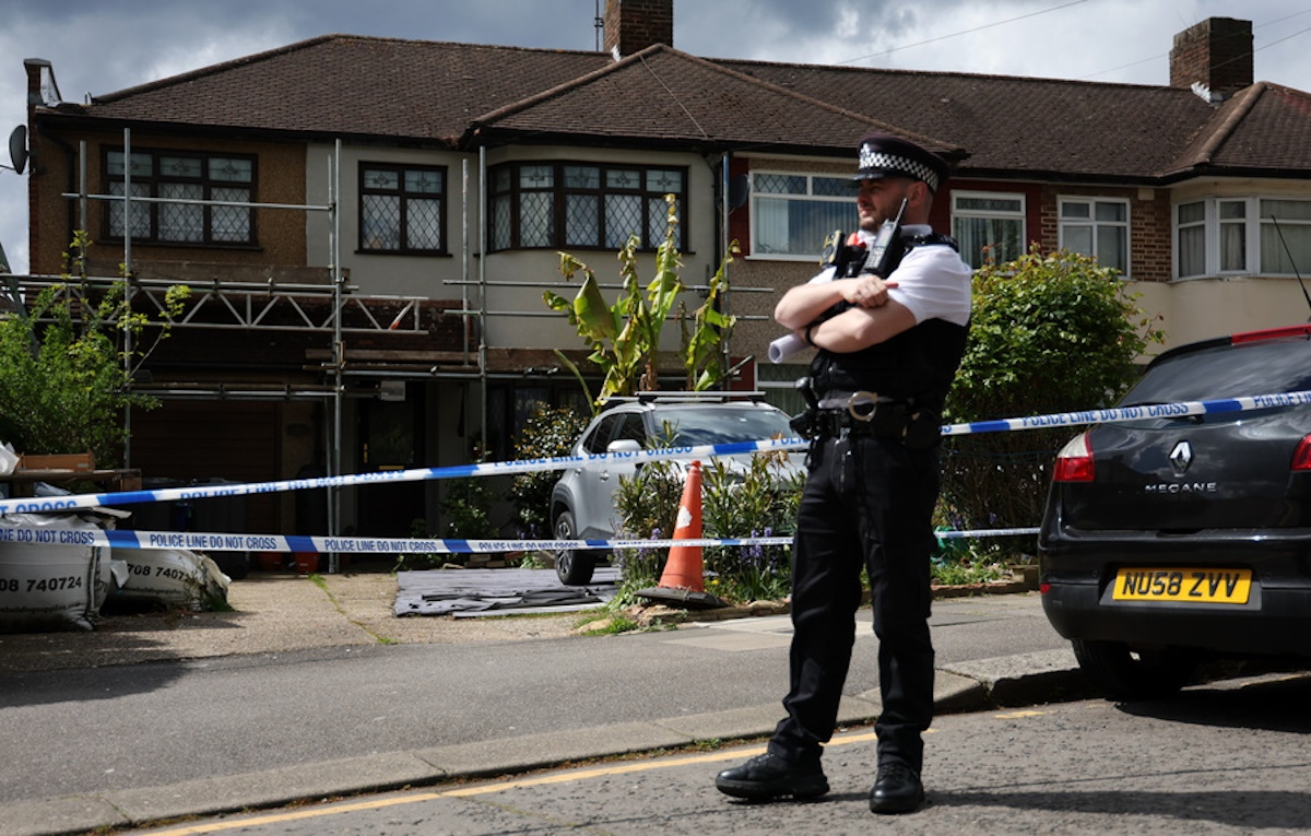 epa11310424 Police stand outside the home of a man arrested for a sword attack in Hainault, east London, Britain, 30 April 2024. London's Metropolitan Police said a 13-year-old boy has died, and four people including two police officers remain in hospital with significant injuries, after an incident in Hainault east London, when a man attacked people with a sword. A 36-year-old man was arrested at the scene and remains in custody.  EPA