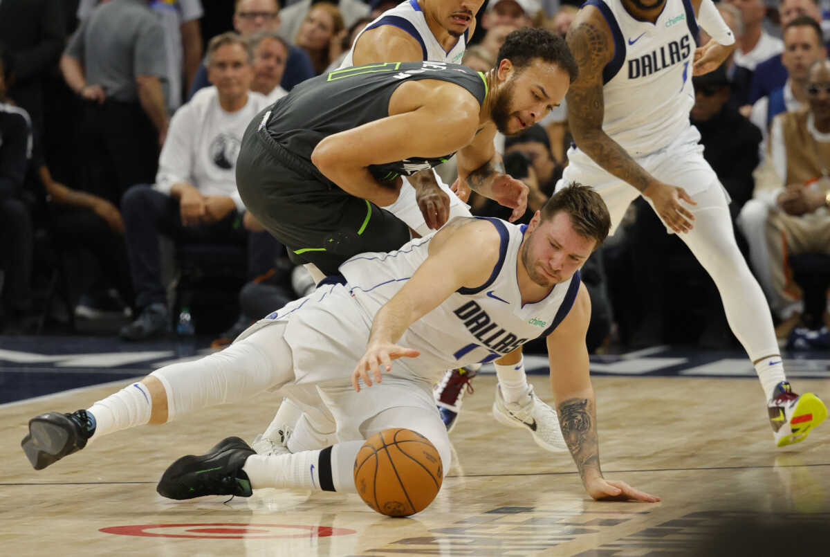 May 30, 2024; Minneapolis, Minnesota, USA; Dallas Mavericks guard Luka Doncic (77) and Minnesota Timberwolves forward Kyle Anderson (1) fight for a loose ball during the second quarter in game five of the western conference finals for the 2024 NBA playoffs at Target Center. Mandatory Credit: Bruce Kluckhohn-USA TODAY Sports