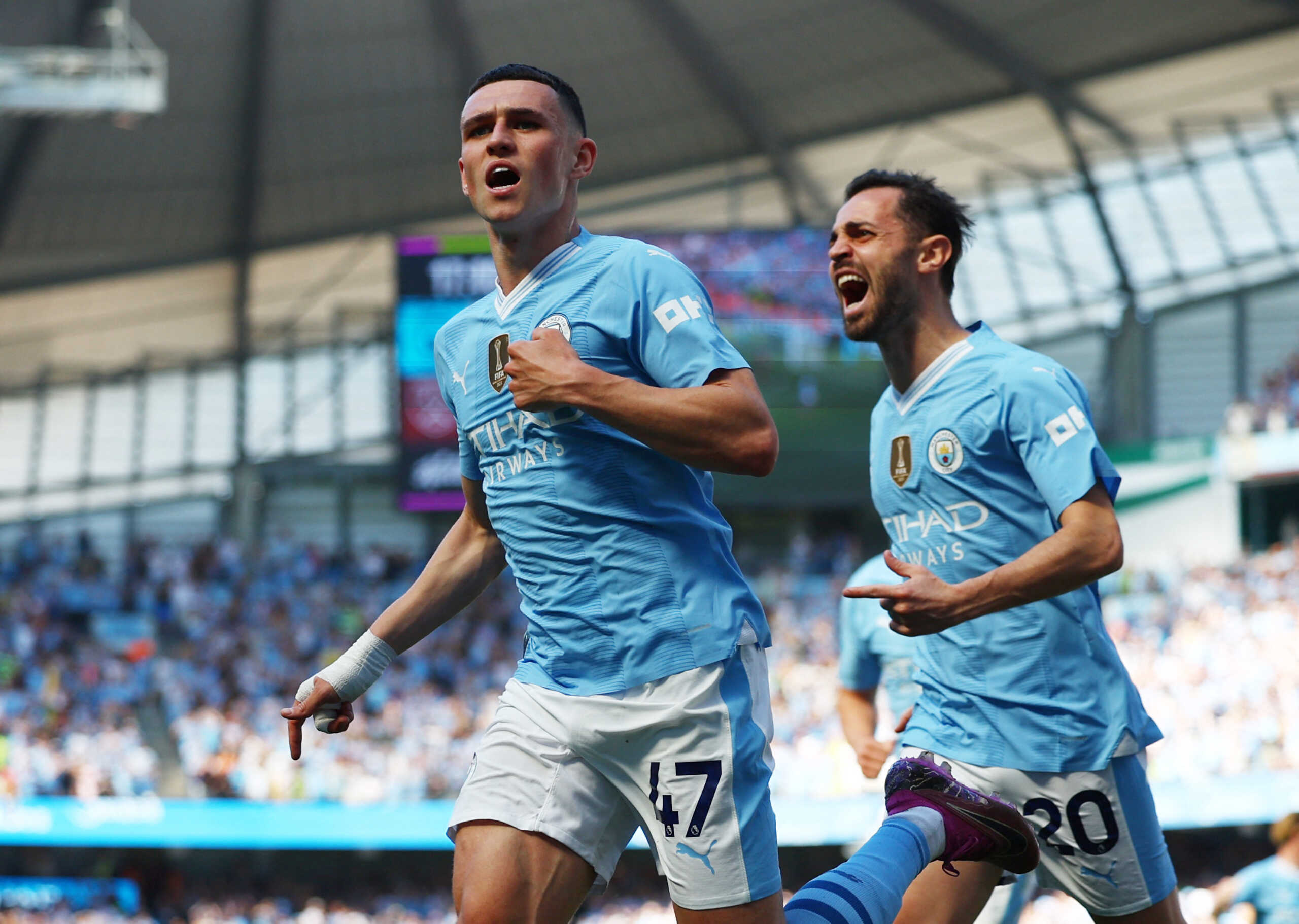 Soccer Football - Premier League - Manchester City v West Ham United - Etihad Stadium, Manchester, Britain - May 19, 2024  Manchester City's Phil Foden celebrates scoring their second goal with Bernardo Silva REUTERS