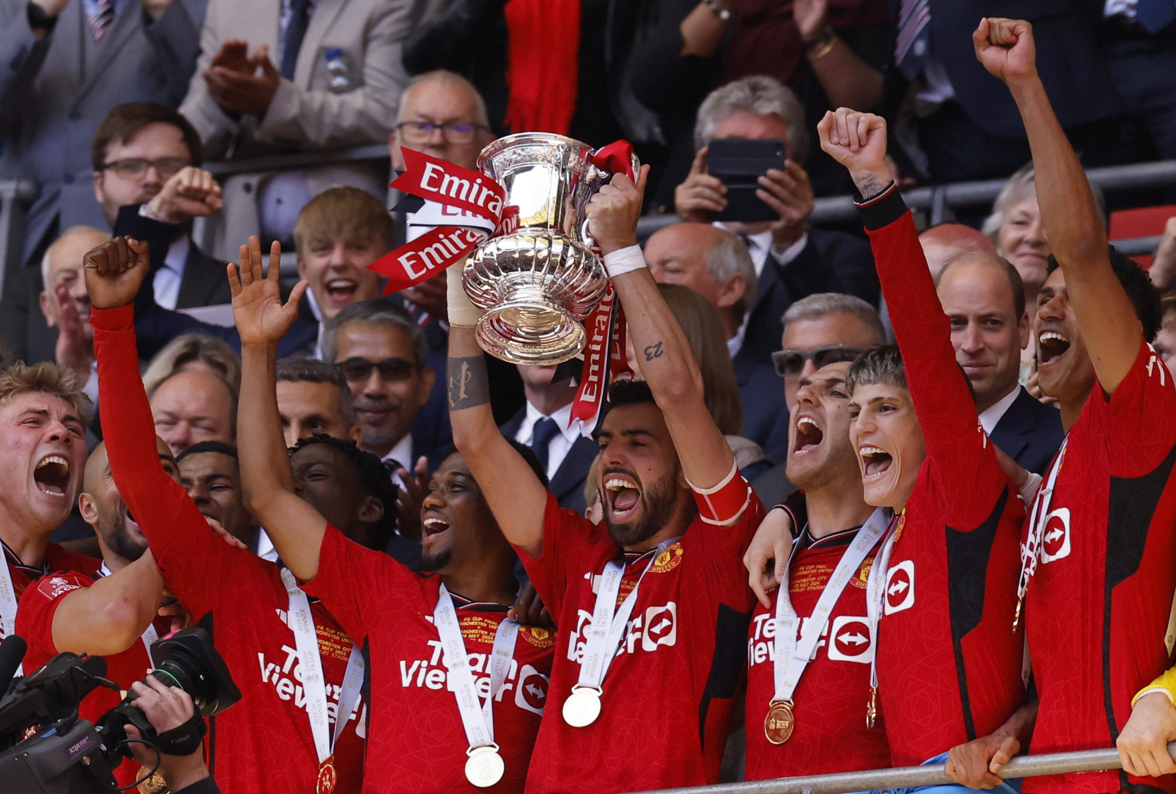 Soccer Football - FA Cup - Final - Manchester City v Manchester United - Wembley Stadium, London, Britain - May 25, 2024 Manchester United's Bruno Fernandes lifts the trophy as he celebrates with teammates after winning the FA Cup Action Images via Reuters