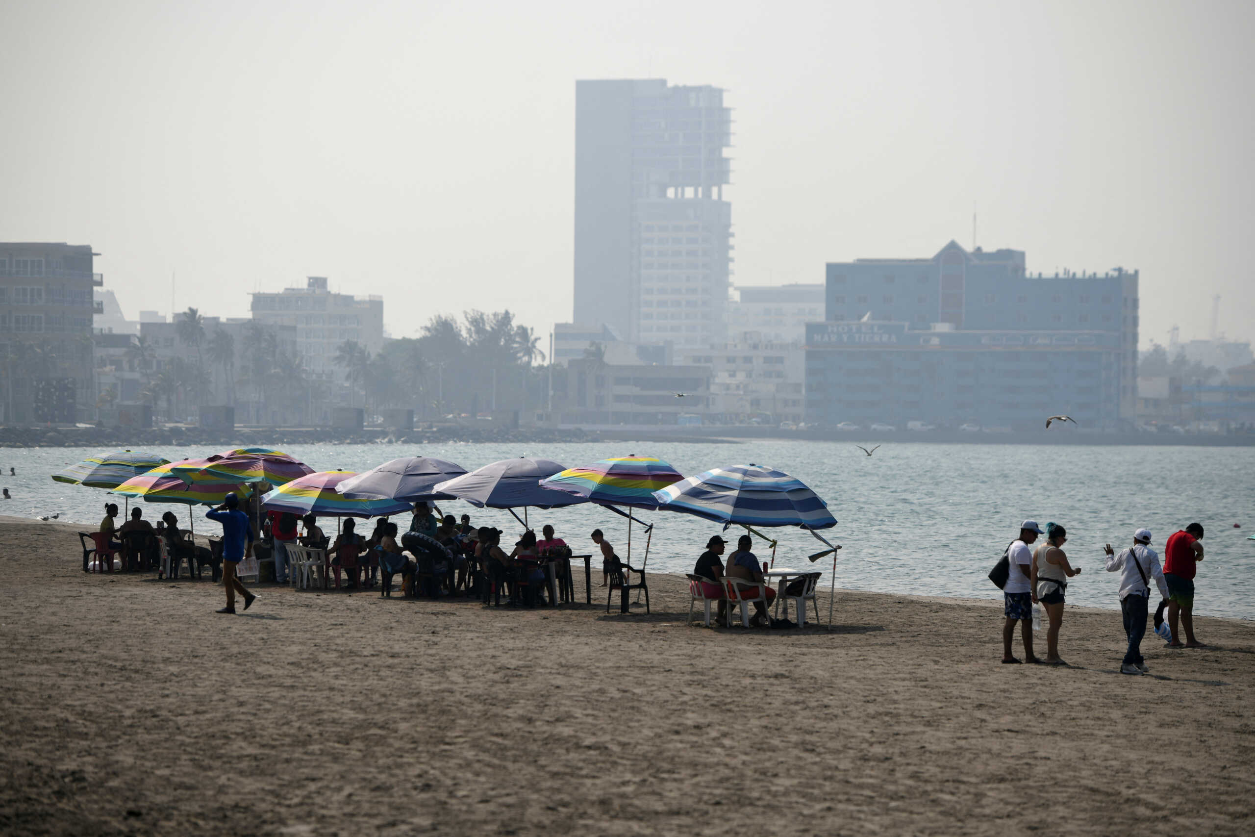 Tourists visit the beach on a hot spring day amid a nationwide drought and heat waves that have sent temperatures soaring across much of the country, in Veracruz, Mexico, May 21, 2024. REUTERS