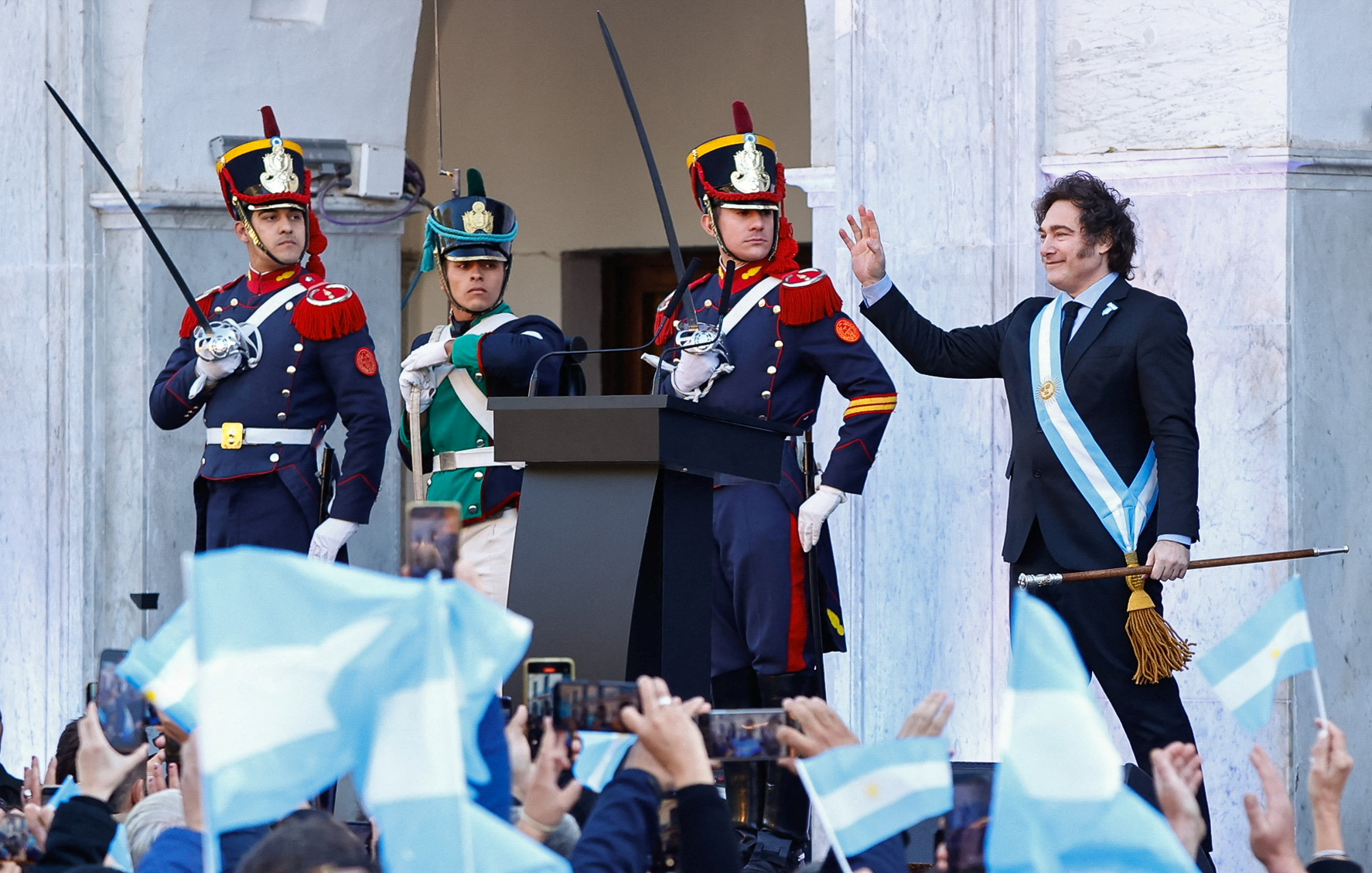 Argentina's President Javier Milei waves to supporters outside the Cabildo during the commemoration of the 214th anniversary of the May Revolution, in Cordoba, Argentina May 25, 2024. REUTERS