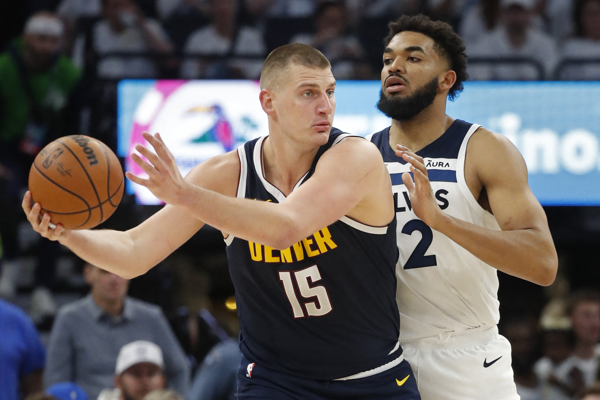May 12, 2024; Minneapolis, Minnesota, USA; Denver Nuggets center Nikola Jokic (15) works around Minnesota Timberwolves forward Karl-Anthony Towns (32) in the third quarter of game four of the second round for the 2024 NBA playoffs at Target Center. Mandatory Credit: Bruce Kluckhohn-USA TODAY Sports