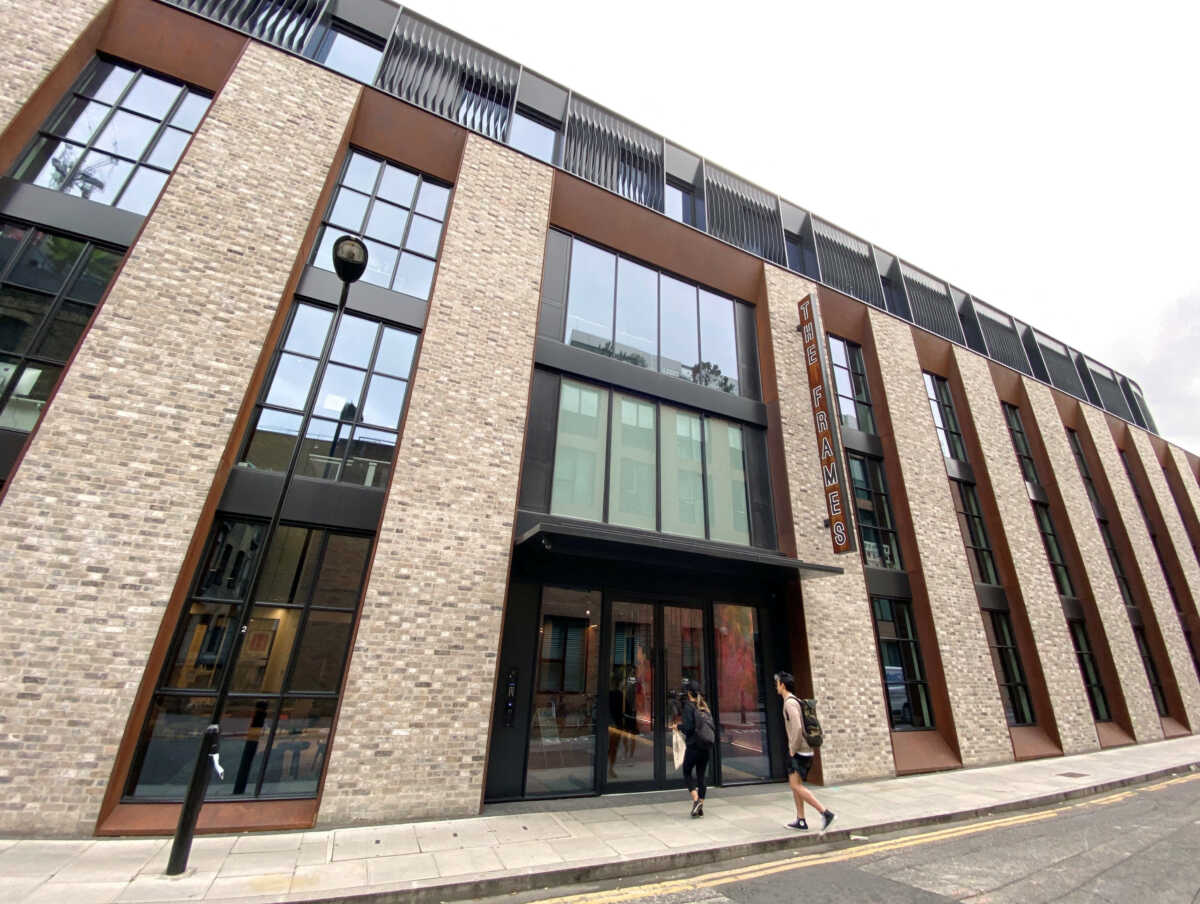 FILE PHOTO: People enter The Frames, an office building owned by Workspace Group Plc, following the outbreak of the coronavirus disease (COVID-19), London, Britain, June 5, 2020.   REUTERS