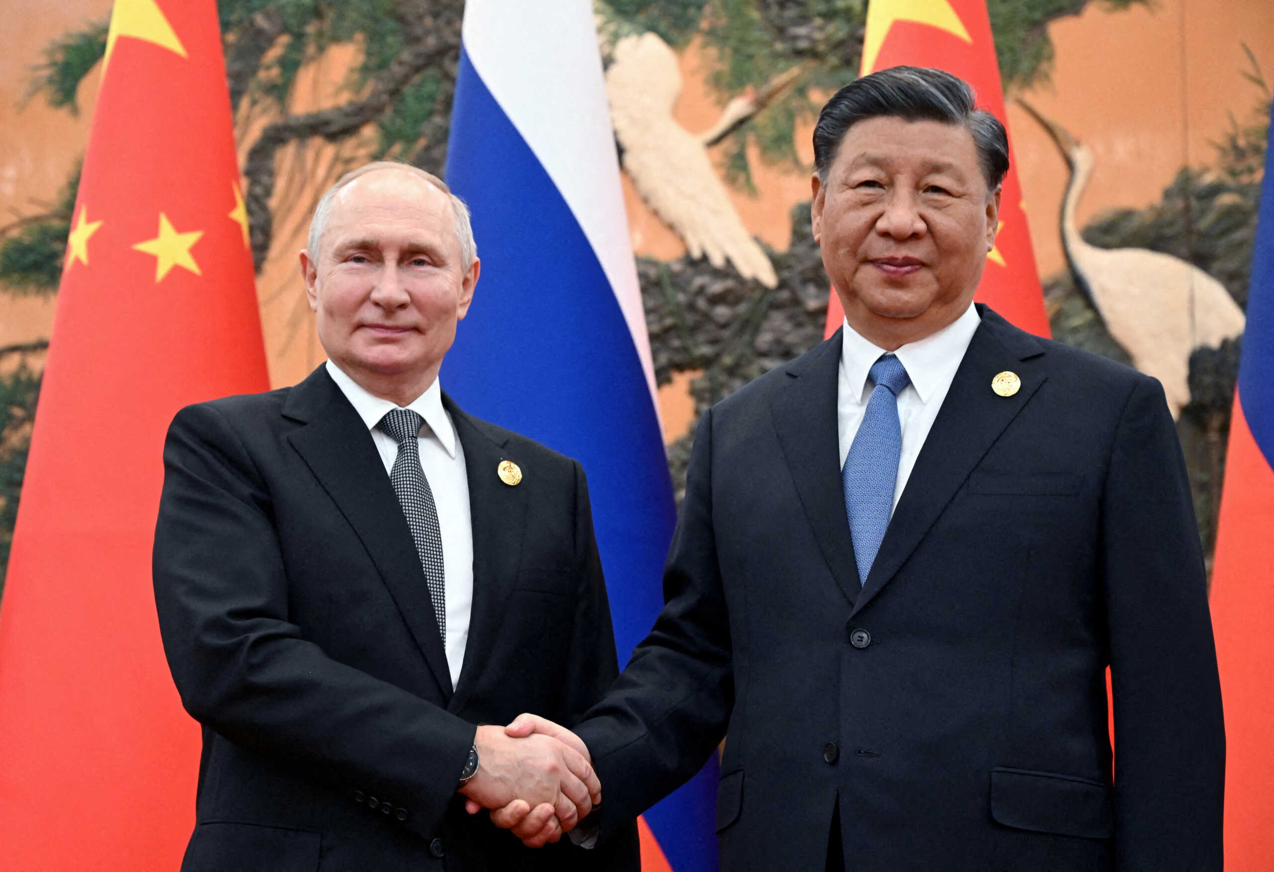 FILE PHOTO: Russian President Vladimir Putin shakes hands with Chinese President Xi Jinping during a meeting at the Belt and Road Forum in Beijing, China, October 18, 2023. Sputnik