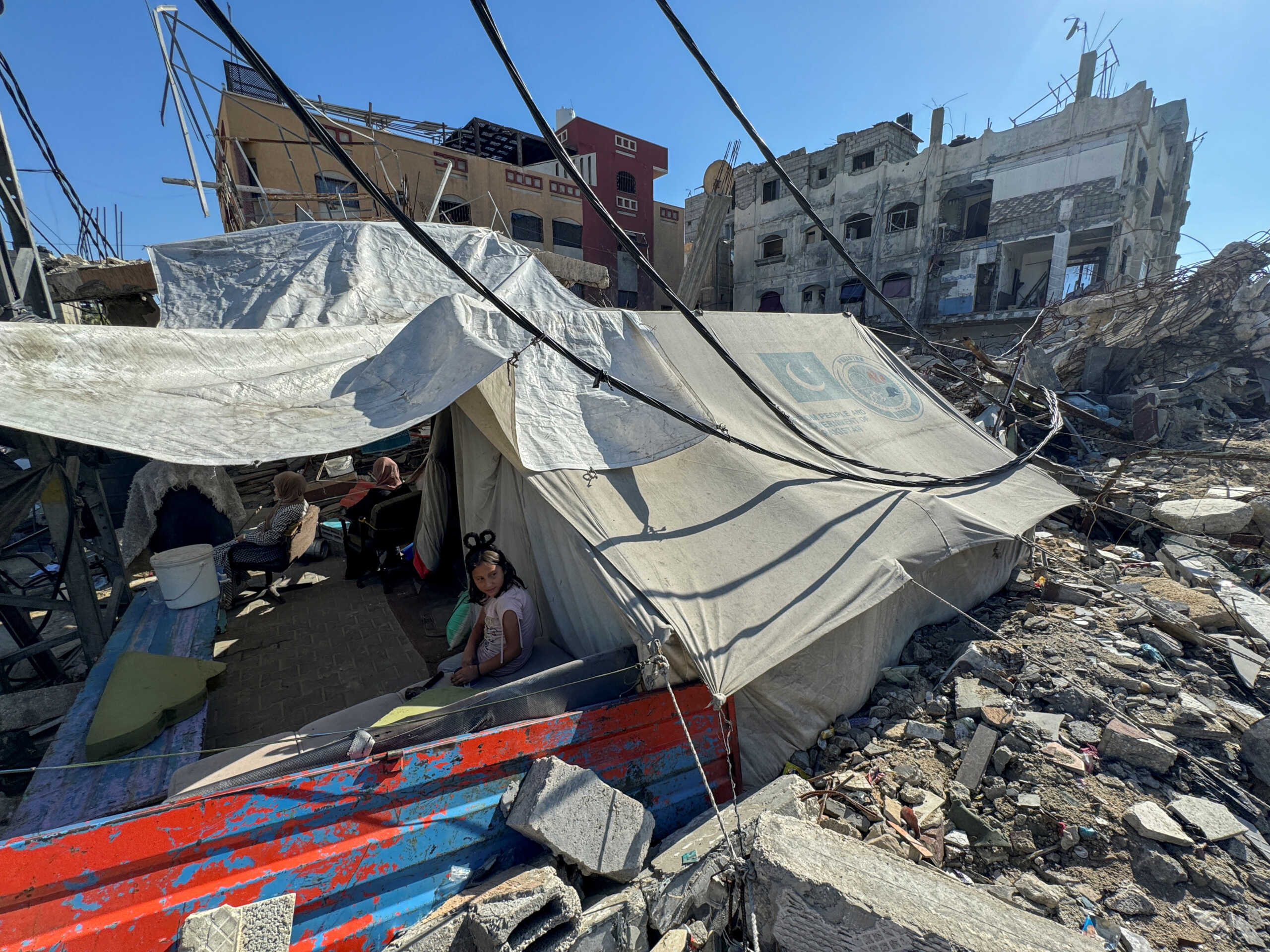 A displaced Palestinian girl, who fled her house due to Israel's military offensive, sits outside her family's tent, in Rafah, in the southern Gaza Strip May 13, 2024. REUTERS
