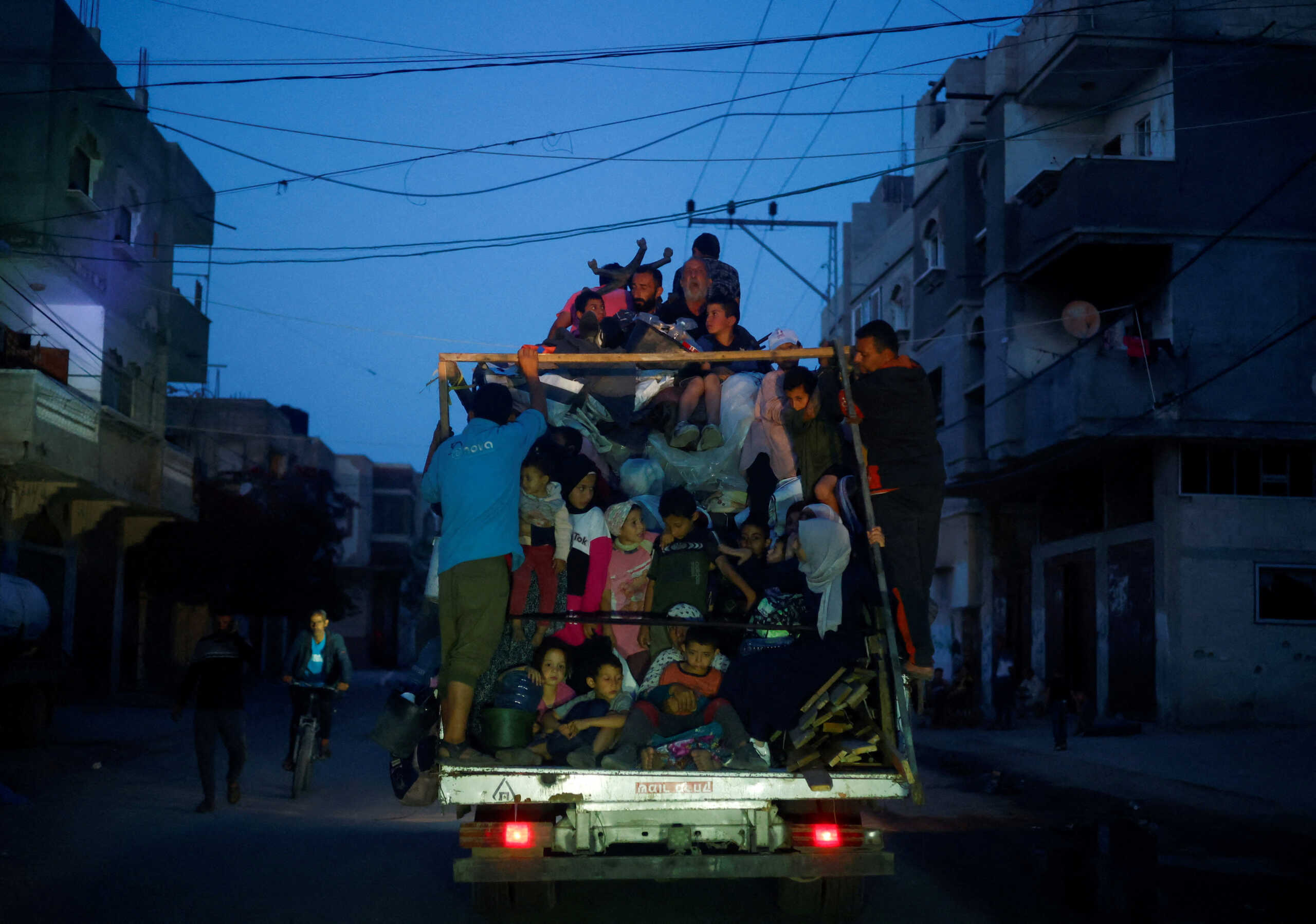Palestinians ride on a vehicle as they flee Rafah after Israeli forces launched a ground and air operation in the eastern part of the southern Gaza City, amid the ongoing conflict between Israel and Hamas, in Rafah, in the southern Gaza Strip May 9, 2024. REUTERS