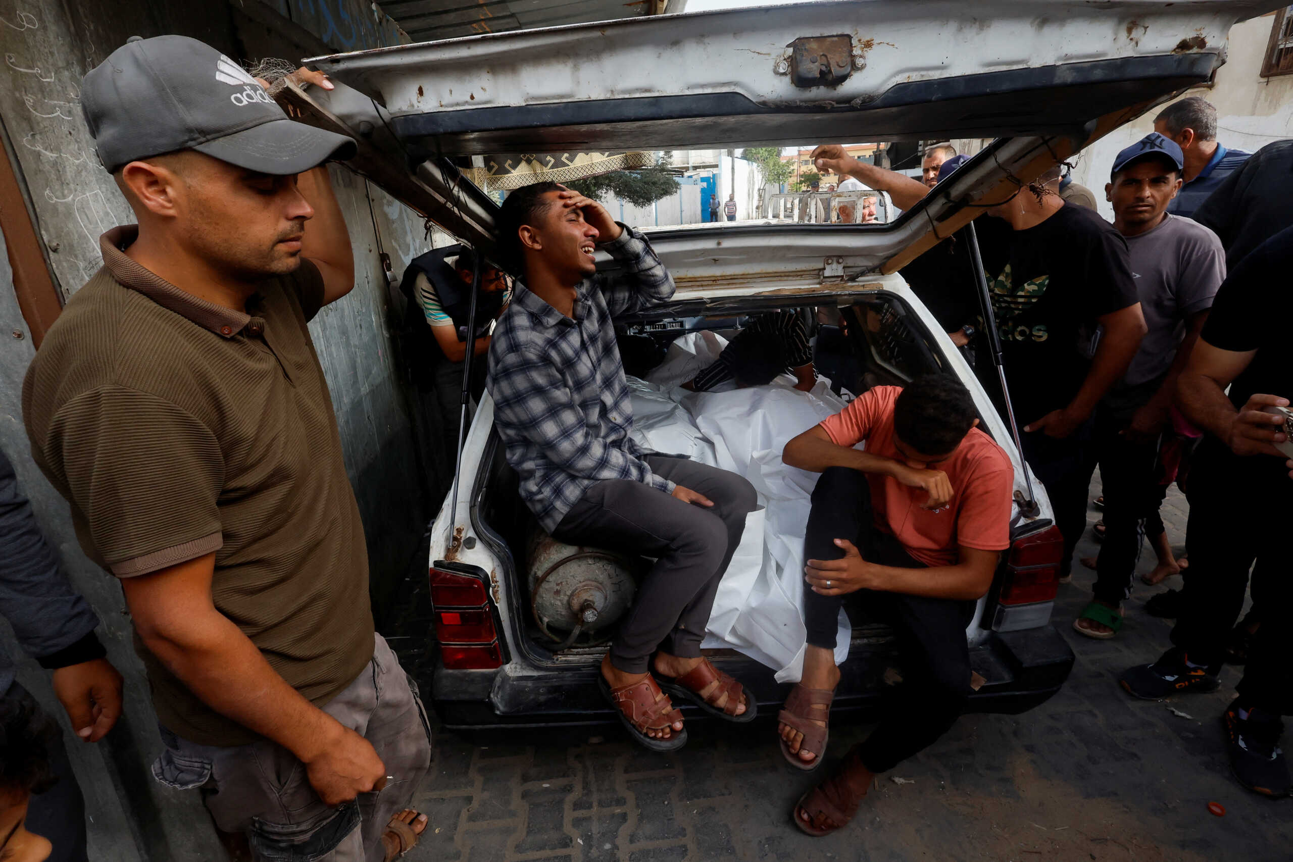 Mourners react next to the bodies of Palestinians killed in an Israeli strike on an area designated for displaced people, during their funeral in Rafah, in the southern Gaza Strip, May 27, 2024. REUTERS