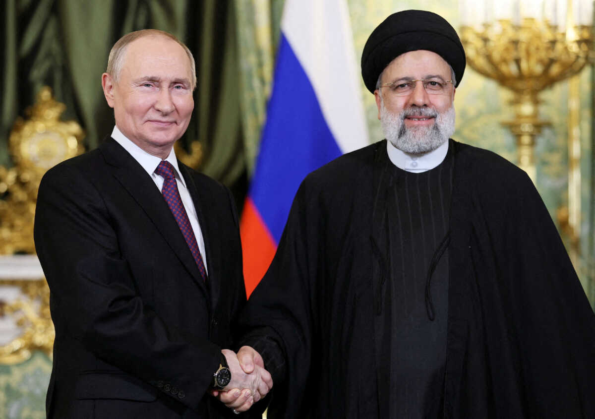 FILE PHOTO: Russian President Vladimir Putin shakes hands with Iranian President Ebrahim Raisi during a meeting in Moscow, Russia December 7, 2023. Sputnik