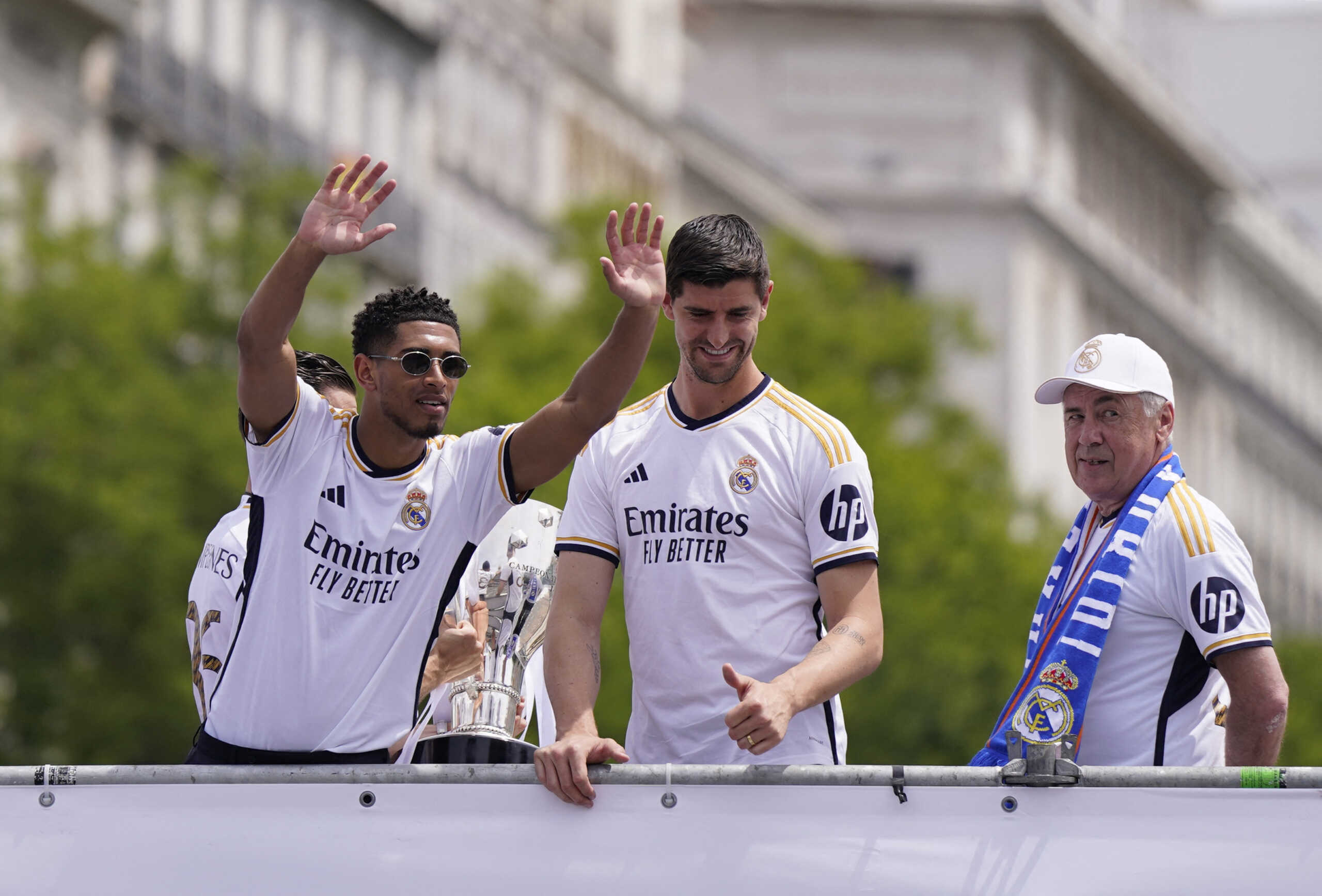 Soccer Football - LaLiga - Real Madrid Celebrate Winning LaLiga - Cibeles Fountain, Madrid, Spain - May 12, 2024 Real Madrid's Jude Bellingham, Thibaut Courtois and coach Carlo Ancelotti wave to the fans from the parade bus during the celebration REUTERS