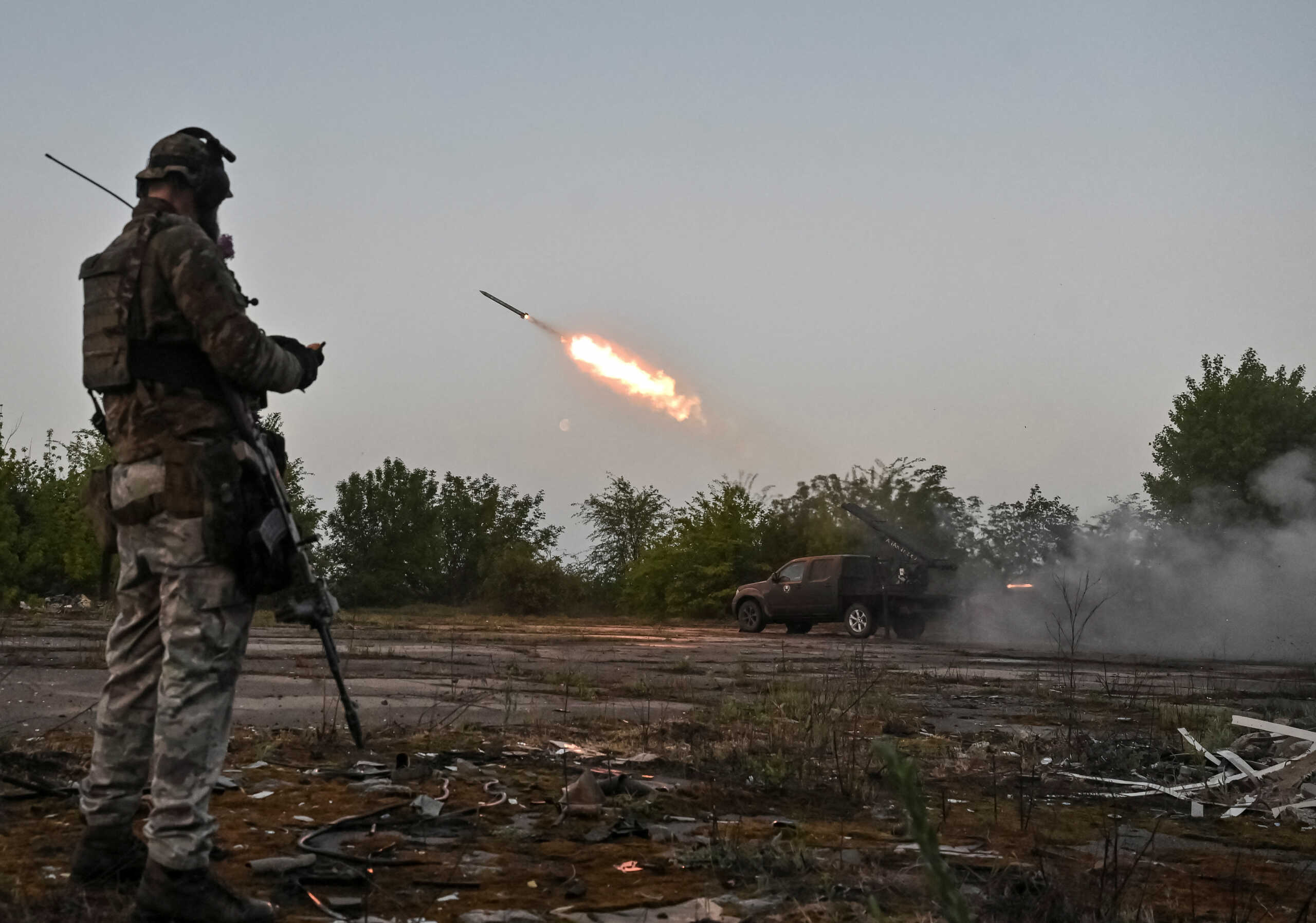 A member of the company tactical group "Steppe Wolves" of the Voluntary Formation of the Zaporizhzhia Territorial Community stands as they fire a handmade small multiple rocket launch system toward Russian troops near a front line, amid Russia's attack on Ukraine, in Zaporizhzhia region, Ukraine April 27, 2024. REUTERS