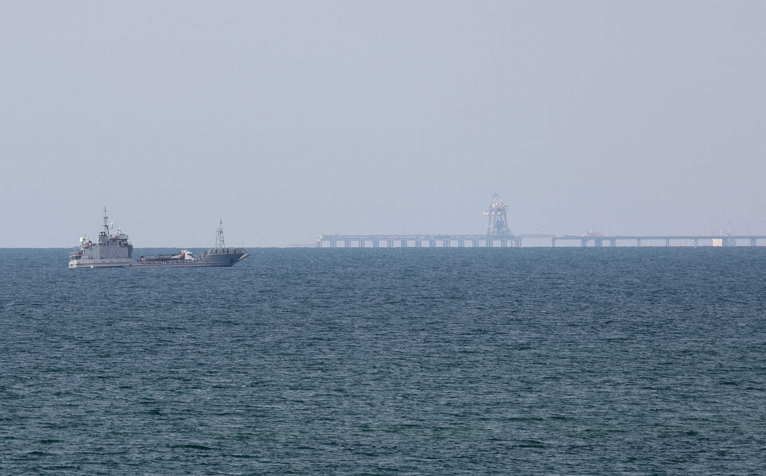 FILE PHOTO: A ship loaded with aid sails near a U.S.-built pier, amid the ongoing conflict between Israel and the Palestinian Islamist group Hamas, as seen from central Gaza Strip, May 18, 2024. REUTERS