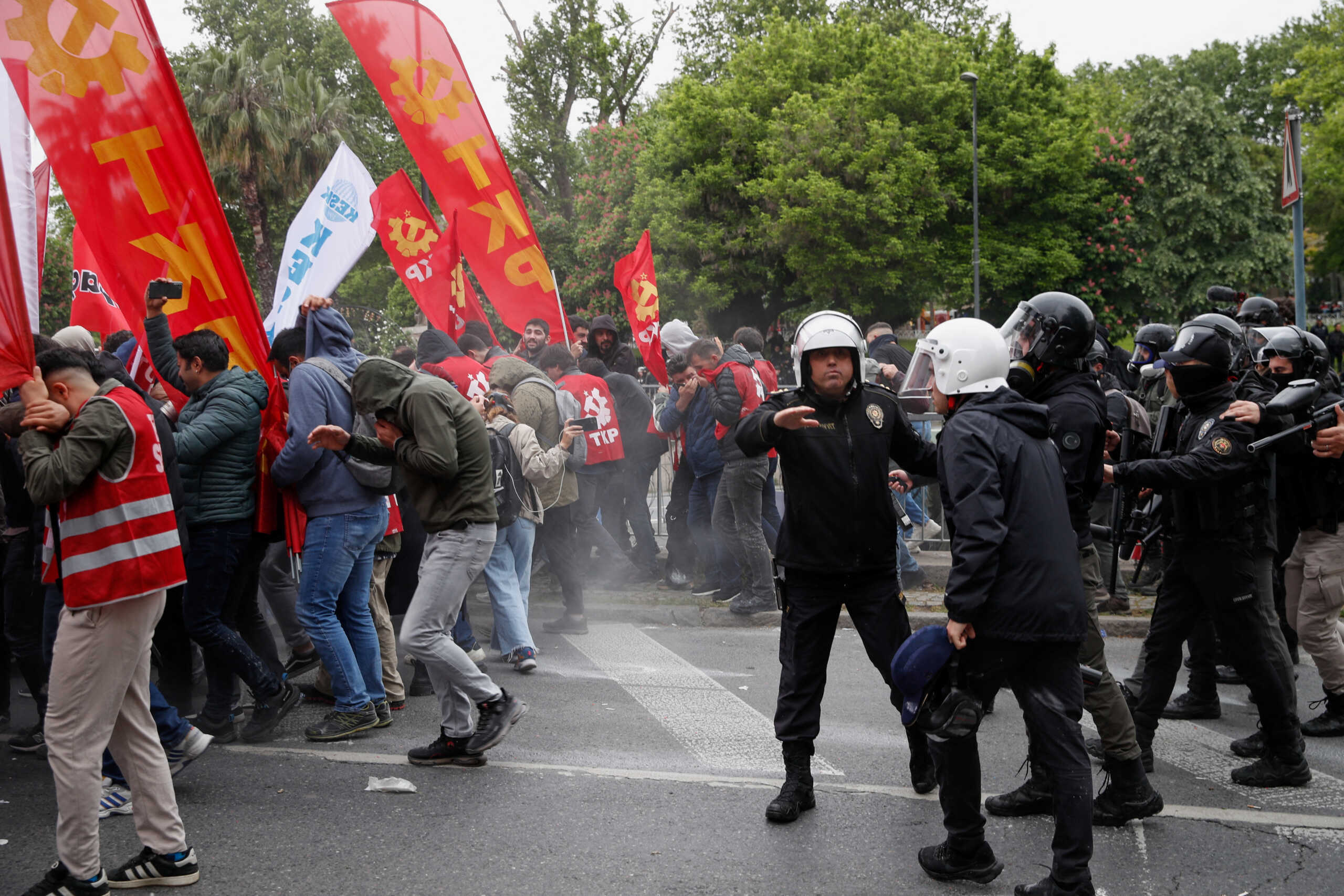 People react after riot police used tear gas during clashes, as protesters attempt to defy a ban and march on Taksim Square to celebrate May Day in Istanbul, Turkey May 1, 2024. REUTERS