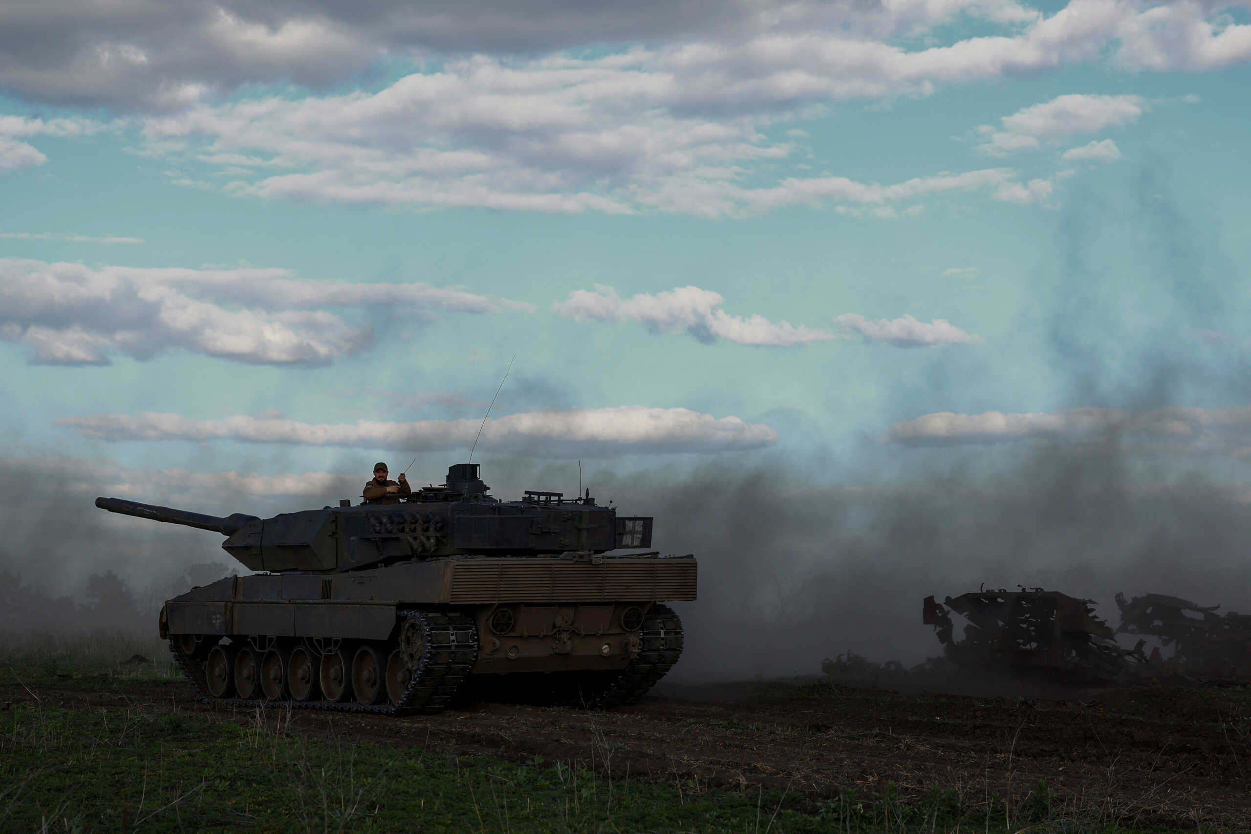 Ukrainian serviceman Andrii, a tank company commander of the 21st Separate Mechanized Brigade, sits atop of a Leopard 2A6 tank during a military exercise, amid Russia's attack on Ukraine, near a front line in Donetsk region, Ukraine May 12, 2024. REUTERS