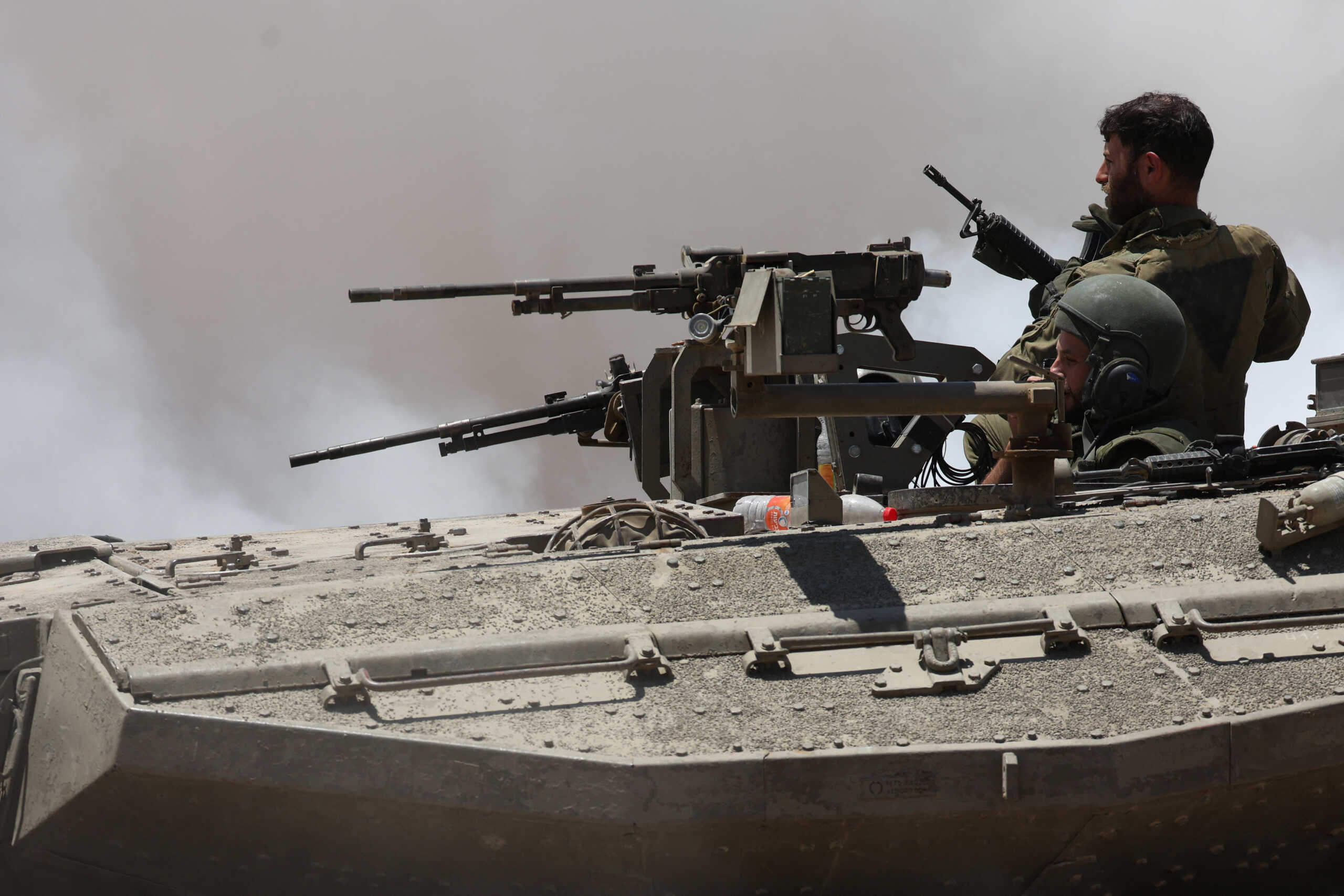 Israeli soldiers sit in a tank near the Israel-Gaza border, amid the ongoing conflict between Israel and the Palestinian Islamist group Hamas, in Israel, May 16, 2024. REUTERS
