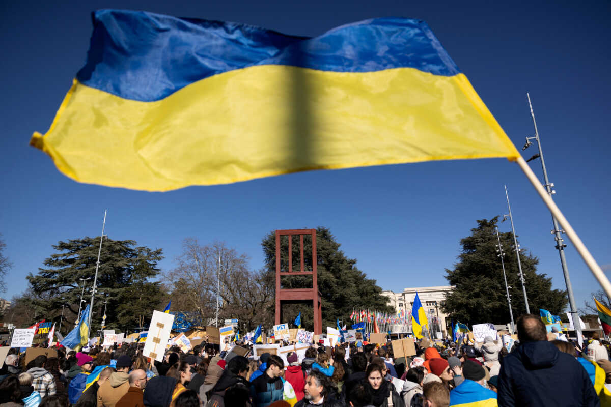 FILE PHOTO: A Ukrainian flag is waved during an anti-war protest, after Russia launched a massive military operation against Ukraine, in front of the United Nations Office in Geneva, Switzerland, February 26, 2022. REUTERS