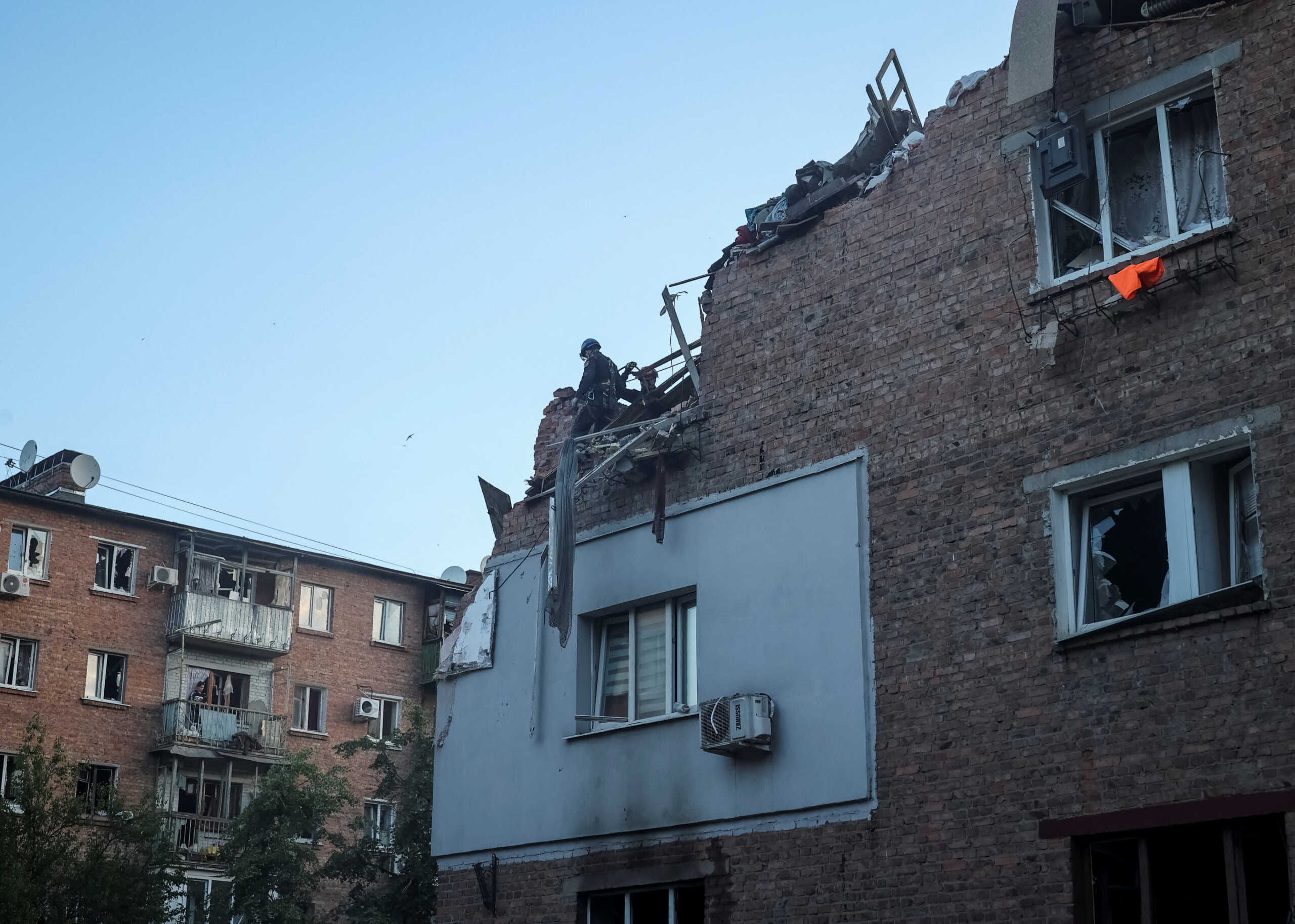 Rescuers work at a site of a residential building hit by a Russian missile strike, amid Russia's attack on Ukraine, in Kharkiv, Ukraine May 31, 2024. REUTERS