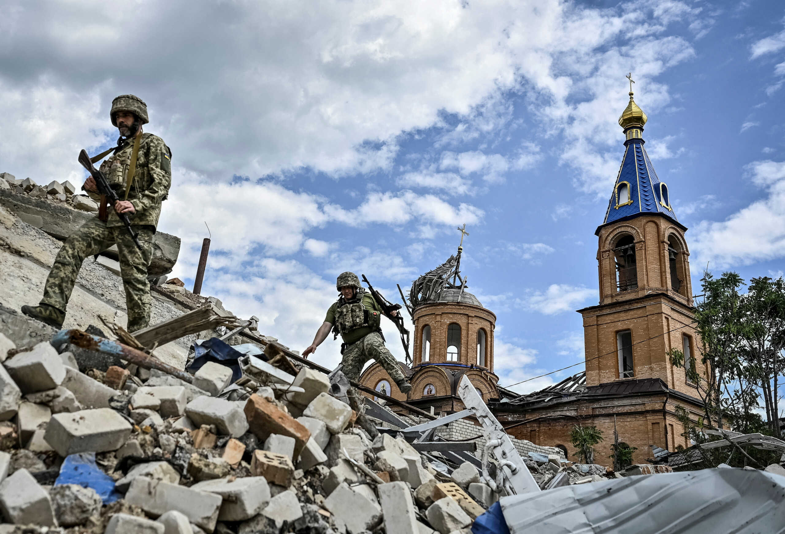 Ukrainian servicemen patrol an area heavily damaged by Russian military strikes, amid Russia's attack on Ukraine, in the town of Orikhiv in Zaporizhzhia region, Ukraine May 20, 2024. REUTERS