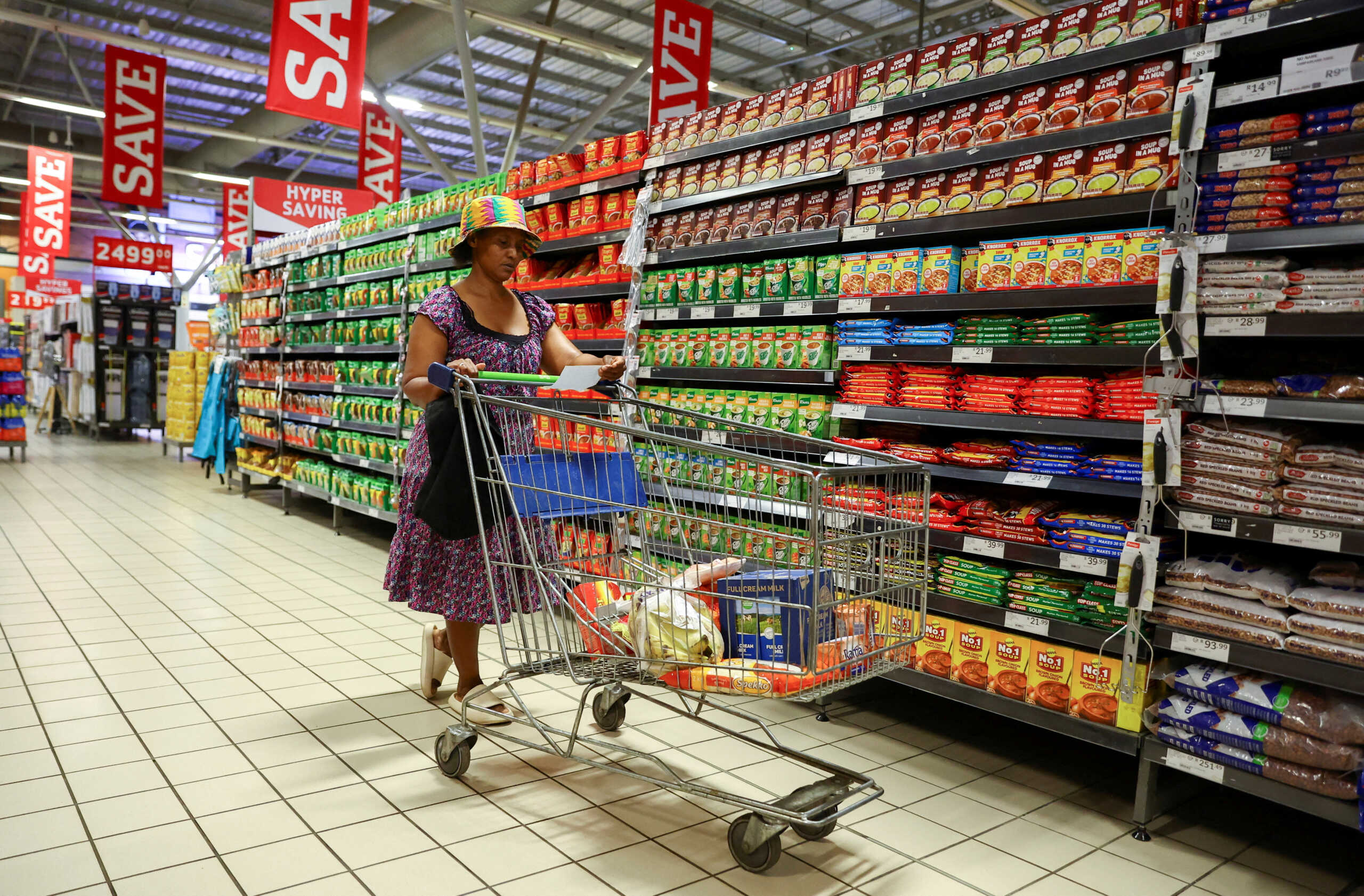 FILE PHOTO: A woman uses a trolley as she shops at a Pick n Pay store at Maponya mall in Soweto, South Africa, October 20, 2022. REUTERS