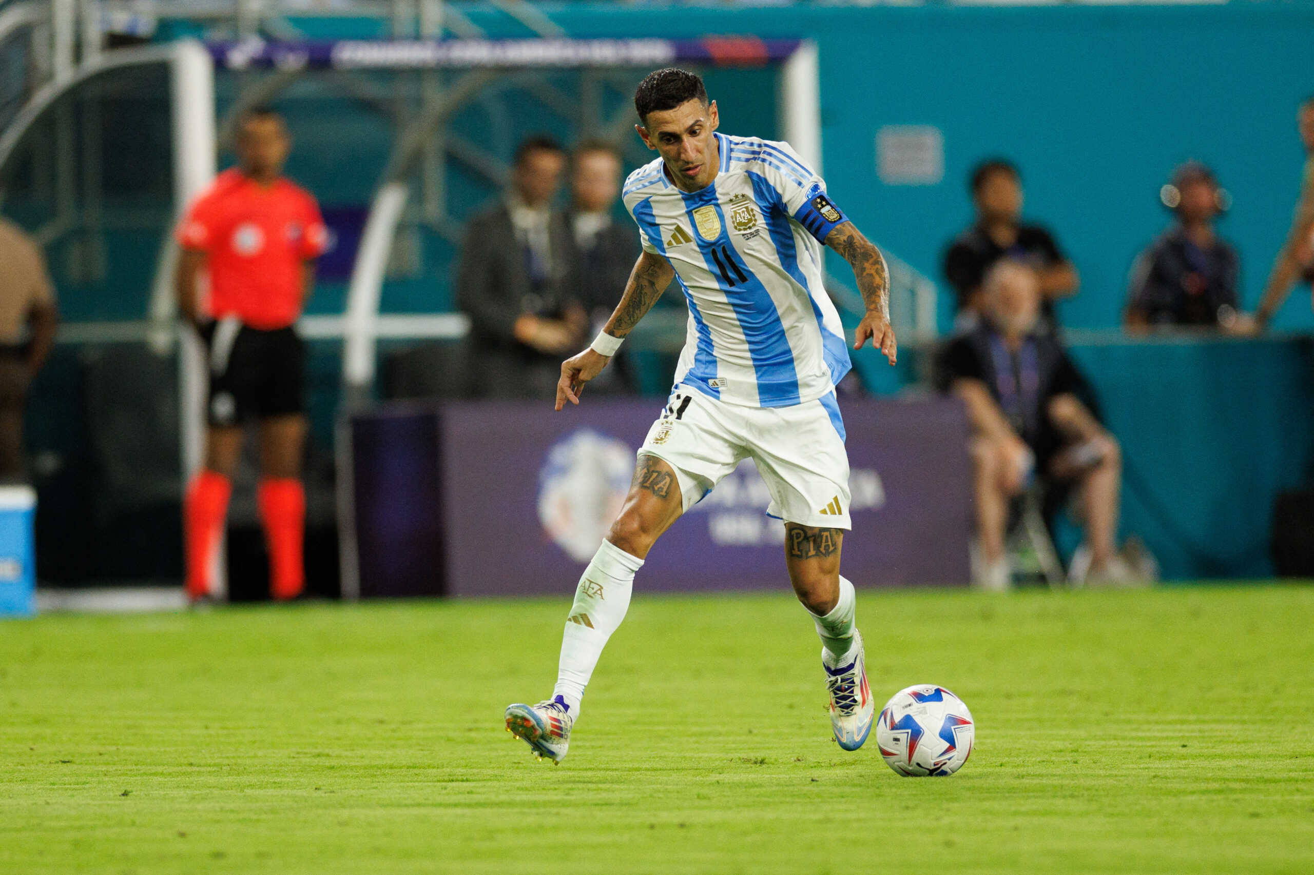 Jun 29, 2024; Miami, FL, USA;  Argentina midfielder Angel Di Maria (11) controls the ball against Peru in the second half during the Copa America group stage at Hard Rock Stadium. Mandatory Credit: Nathan Ray Seebeck-USA TODAY Sports
