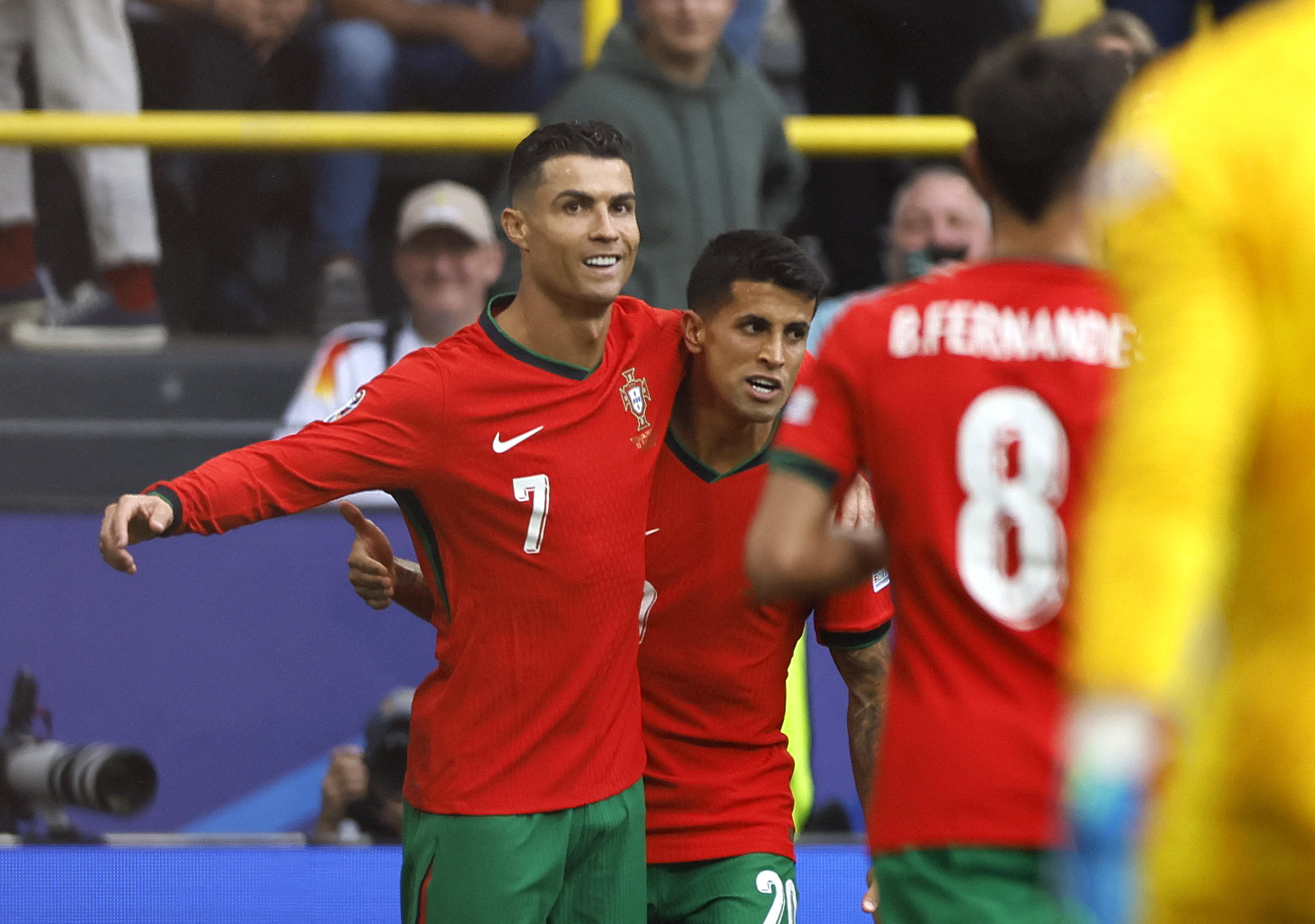 Soccer Football - Euro 2024 - Group F - Turkey v Portugal - Dortmund BVB Stadion, Dortmund, Germany - June 22, 2024 Portugal's Cristiano Ronaldo and Joao Cancelo celebrate after Bruno Fernandes scores their third goal REUTERS
