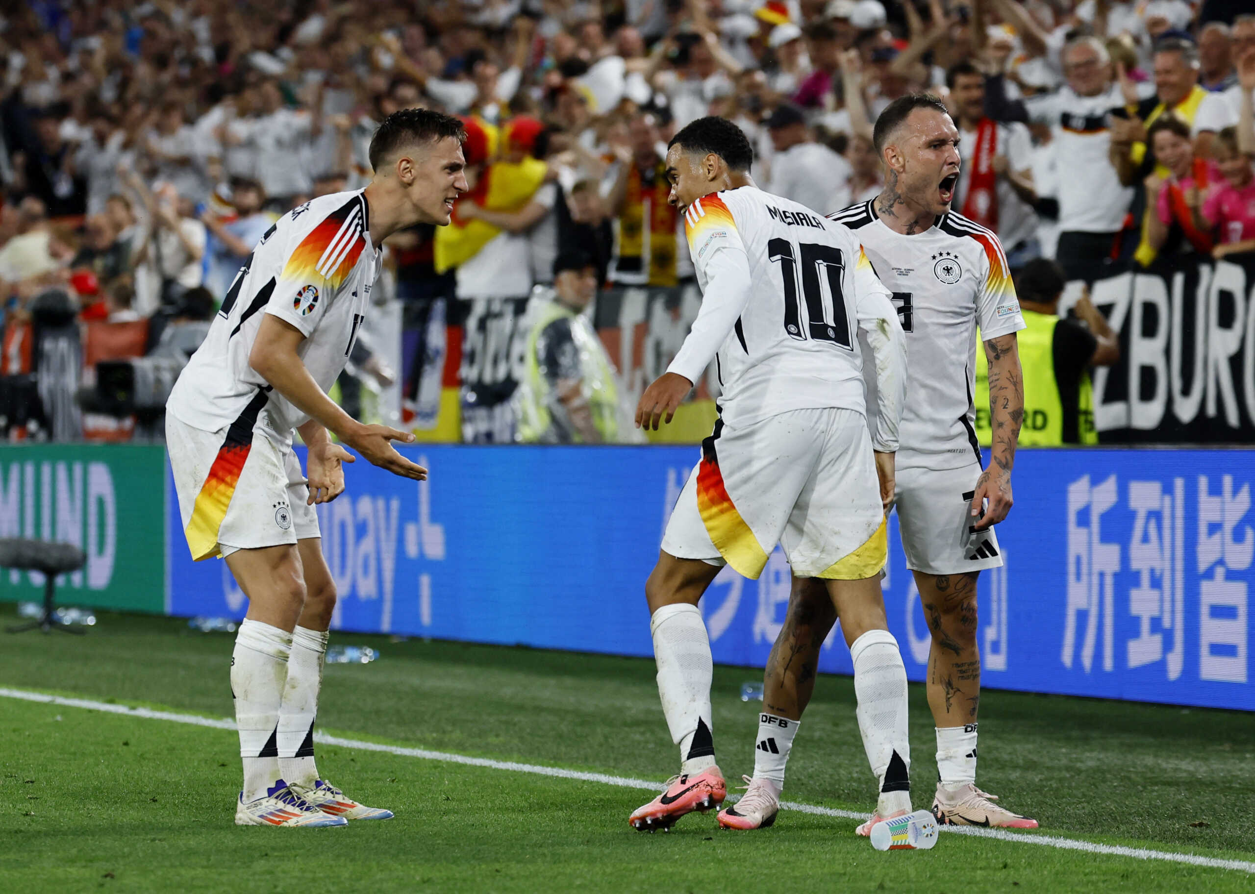 Soccer Football - Euro 2024 - Round of 16 - Germany v Denmark - Dortmund BVB Stadion, Dortmund, Germany - June 29, 2024 Germany's Jamal Musiala celebrates scoring their second goal with David Raum and Nico Schlotterbeck REUTERS