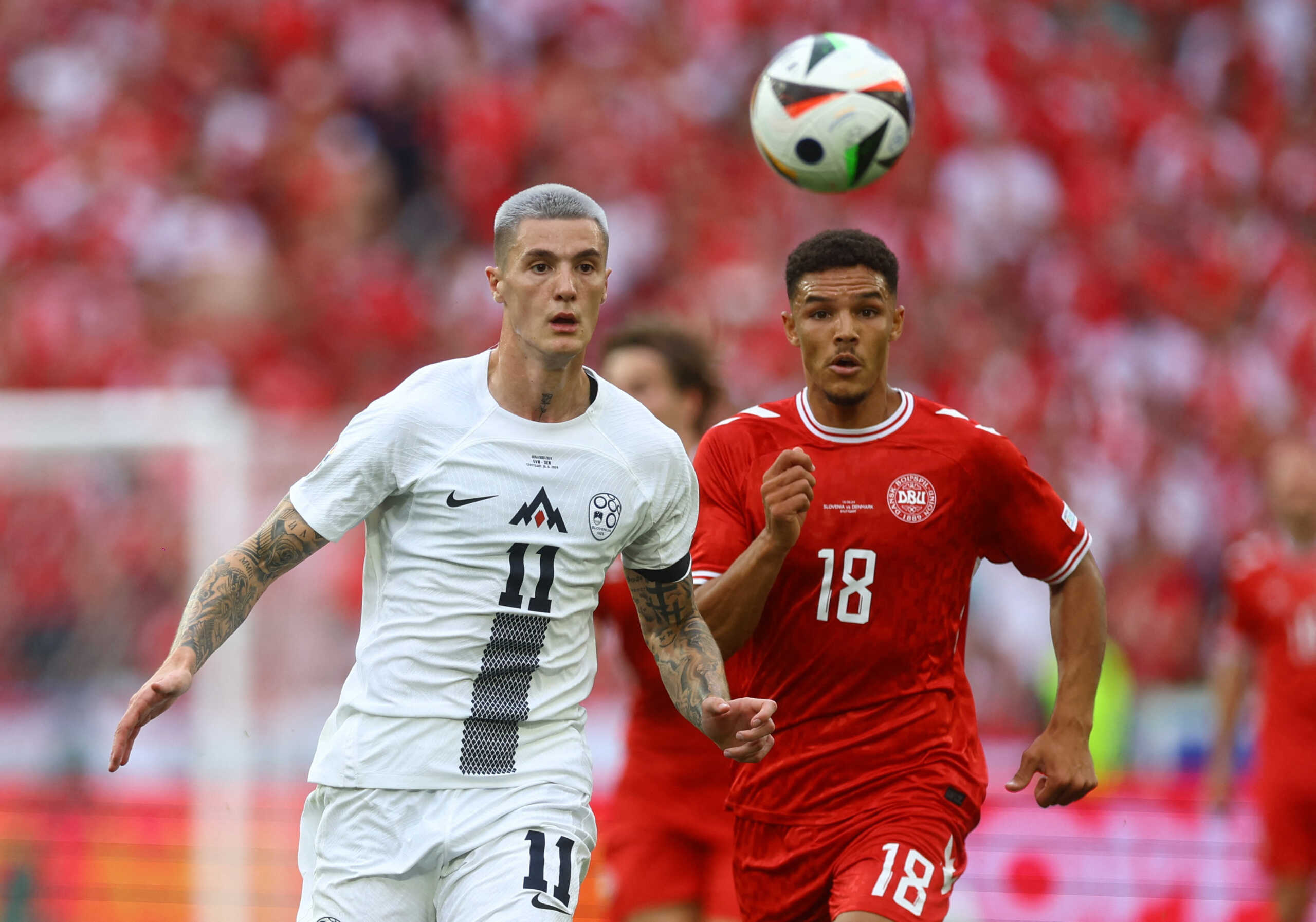 Soccer Football - Euro 2024 - Group C - Slovenia v Denmark - Stuttgart Arena, Stuttgart, Germany - June 16, 2024 Slovenia's Benjamin Sesko in action with Denmark's Alexander Bah REUTERS
