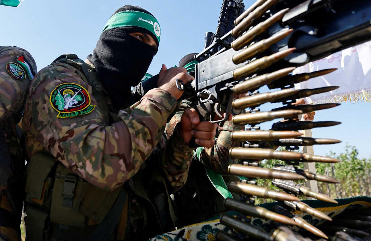 FILE PHOTO: A Palestinian fighter from the armed wing of Hamas takes part in a military parade to mark the anniversary of the 2014 war with Israel, near the border in the central Gaza Strip, July 19, 2023. REUTERS