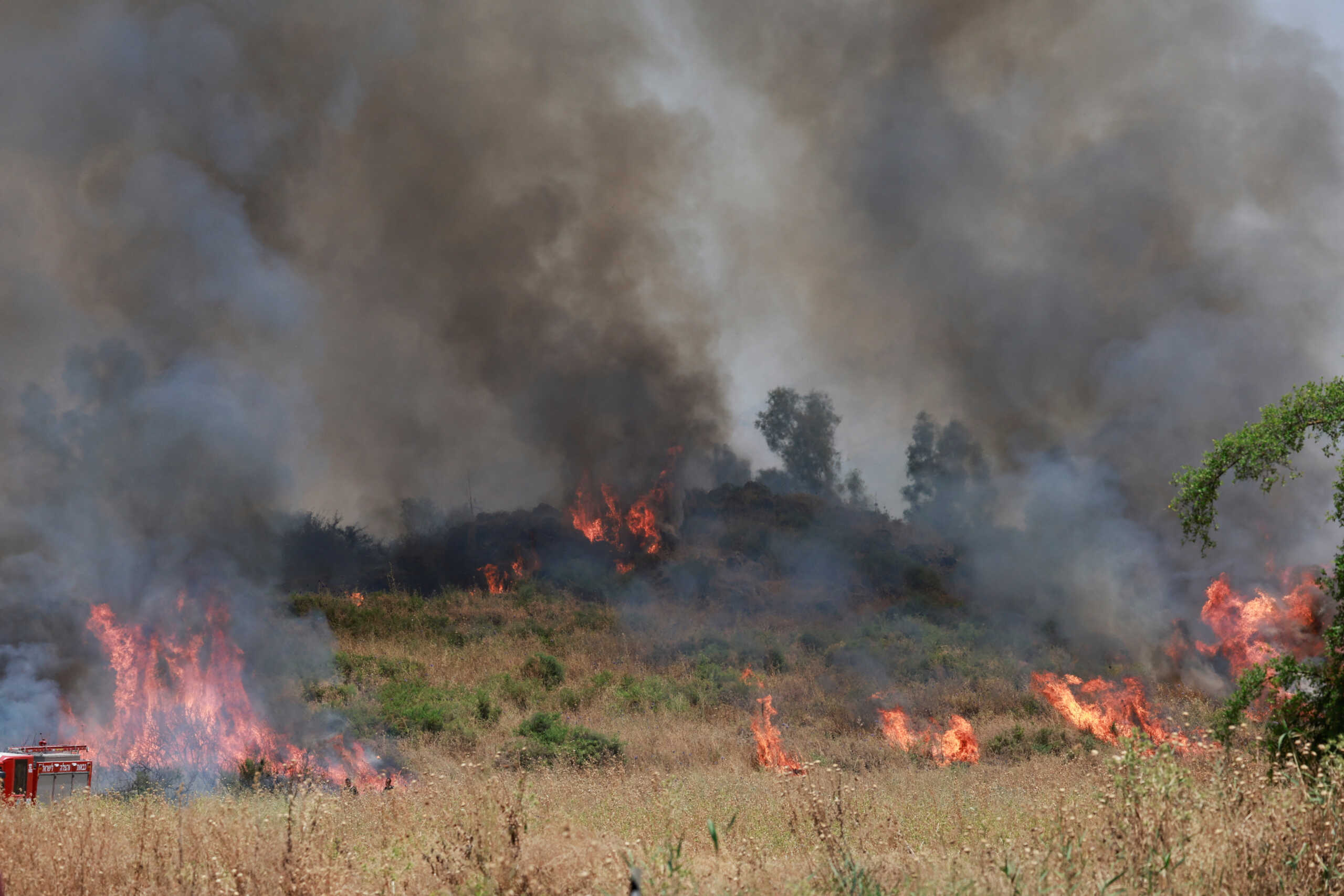 Firefighters respond to a fire near a rocket attack from Lebanon, amid ongoing cross-border hostilities between Hezbollah and Israeli forces, near Kiryat Shmona, northern Israel, June 14, 2024. REUTERS