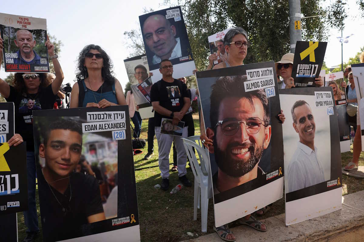 Supporters and families of hostages who were kidnapped during the deadly October 7 attack by Palestinian Islamist group Hamas, hold pictures of their loved ones and demand their release, amid the ongoing conflict between Israel and Hamas, outside the Knesset, Israel's parliament in Jerusalem, June 3, 2024. REUTERS