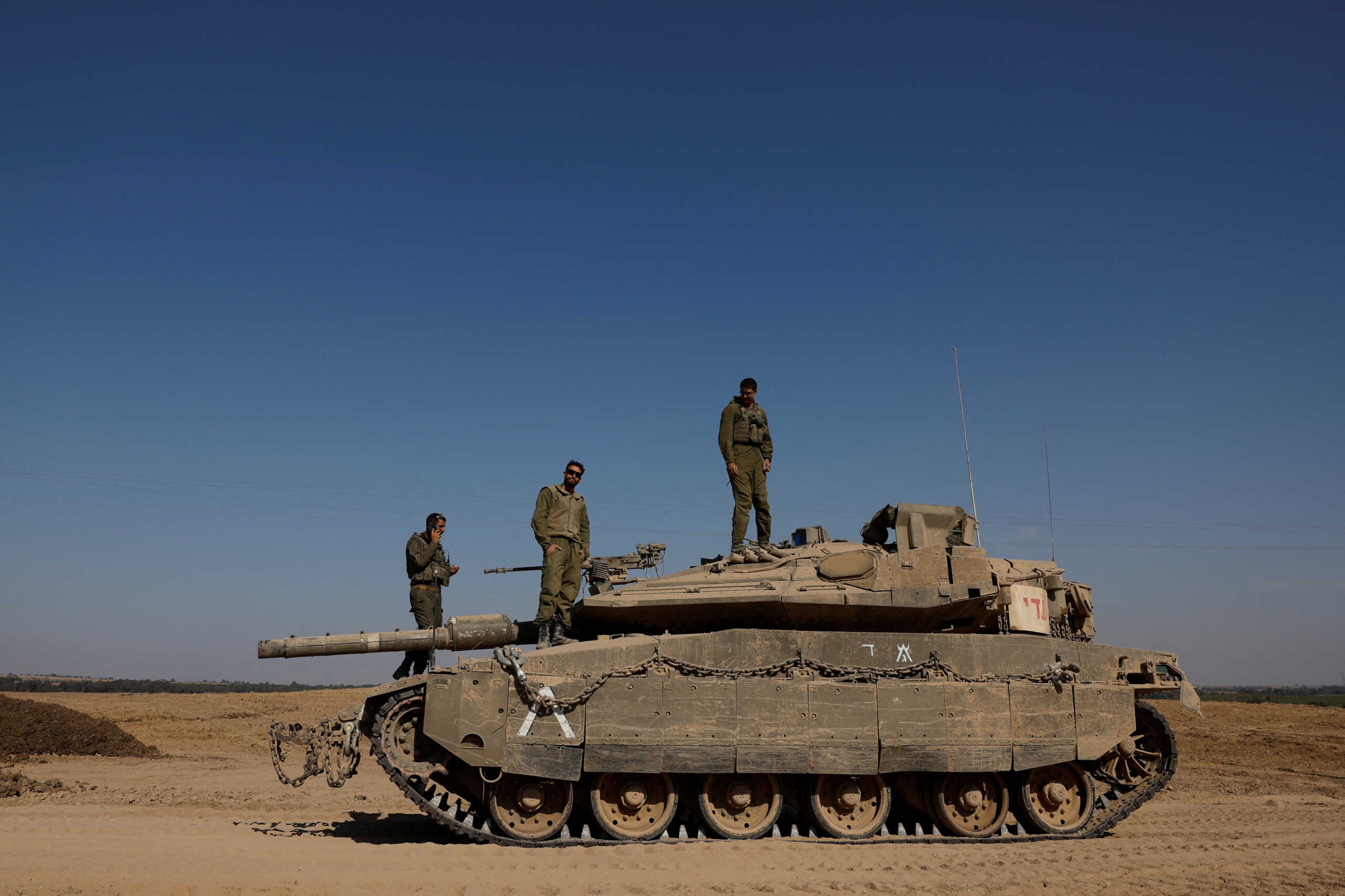 Israeli soldiers stand on top of a tank, amid the ongoing conflict between Israel and Hamas, near the Israel-Gaza border, in Israel, June 6, 2024. REUTERS