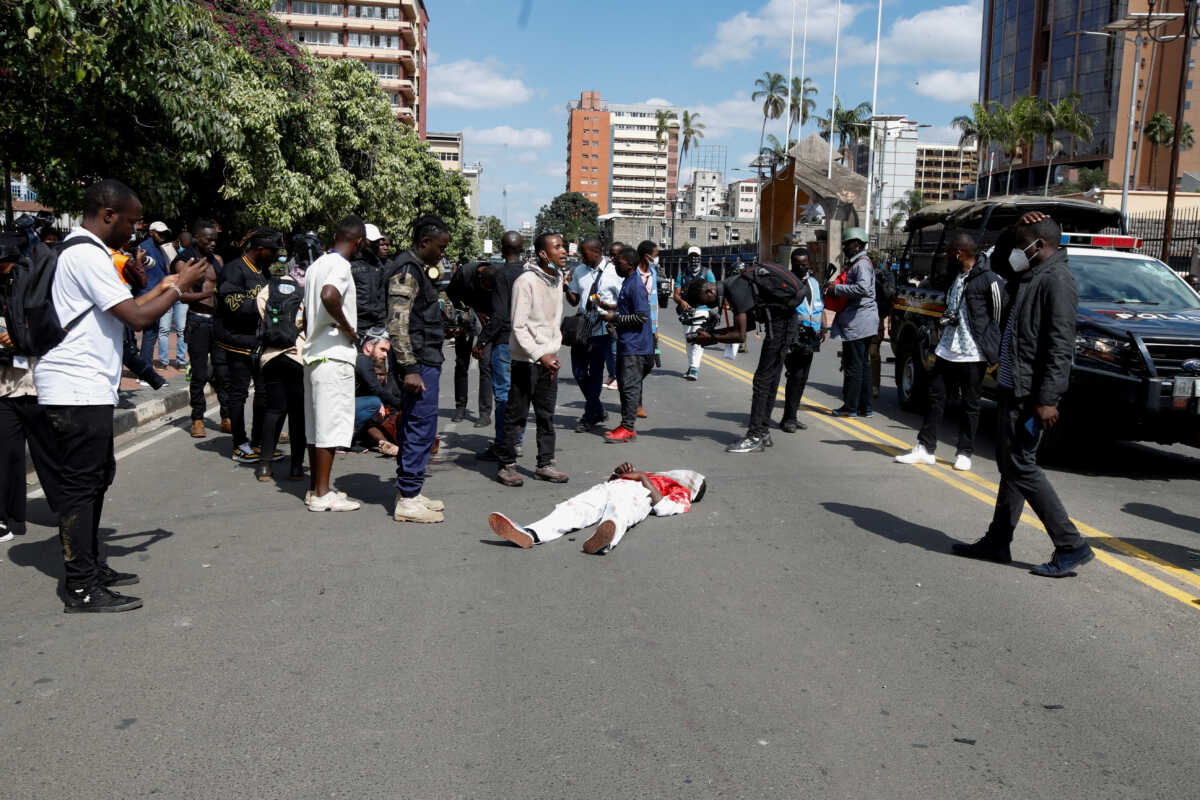 SENSITIVE MATERIAL. THIS IMAGE MAY OFFEND OR DISTURB    Protesters gather around the body of a person killed during clashes between police and people protesting against Kenya's proposed finance bill 2024