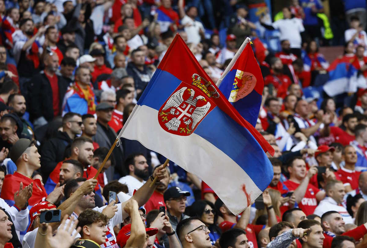Soccer Football - Euro 2024 - Group C - Serbia v England - Arena AufSchalke, Gelsenkirchen, Germany - June 16, 2024 Serbia fans wave the flag of Serbia in the stands before the match REUTERS