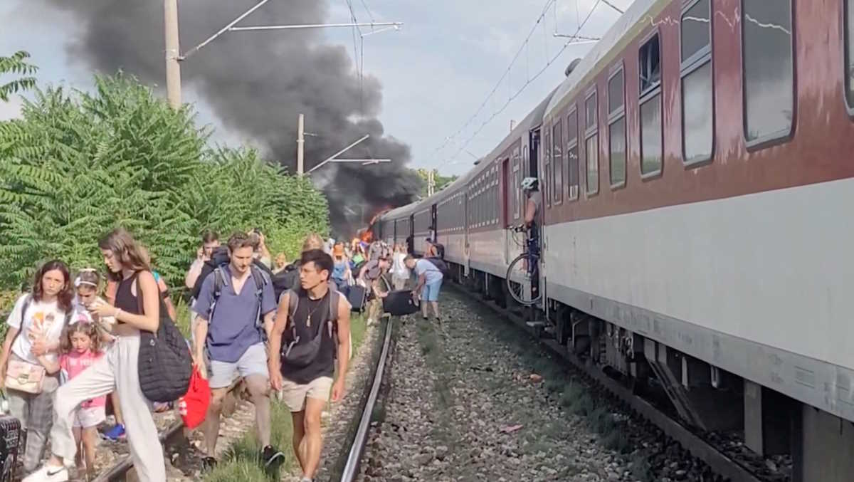 Smoke billows from a fire while people evacuate from a train, near Nove Zamky, Slovakia, June 27, 2024, in this still image obtained from social media video. Katarina Molnarova Perlacosmetic