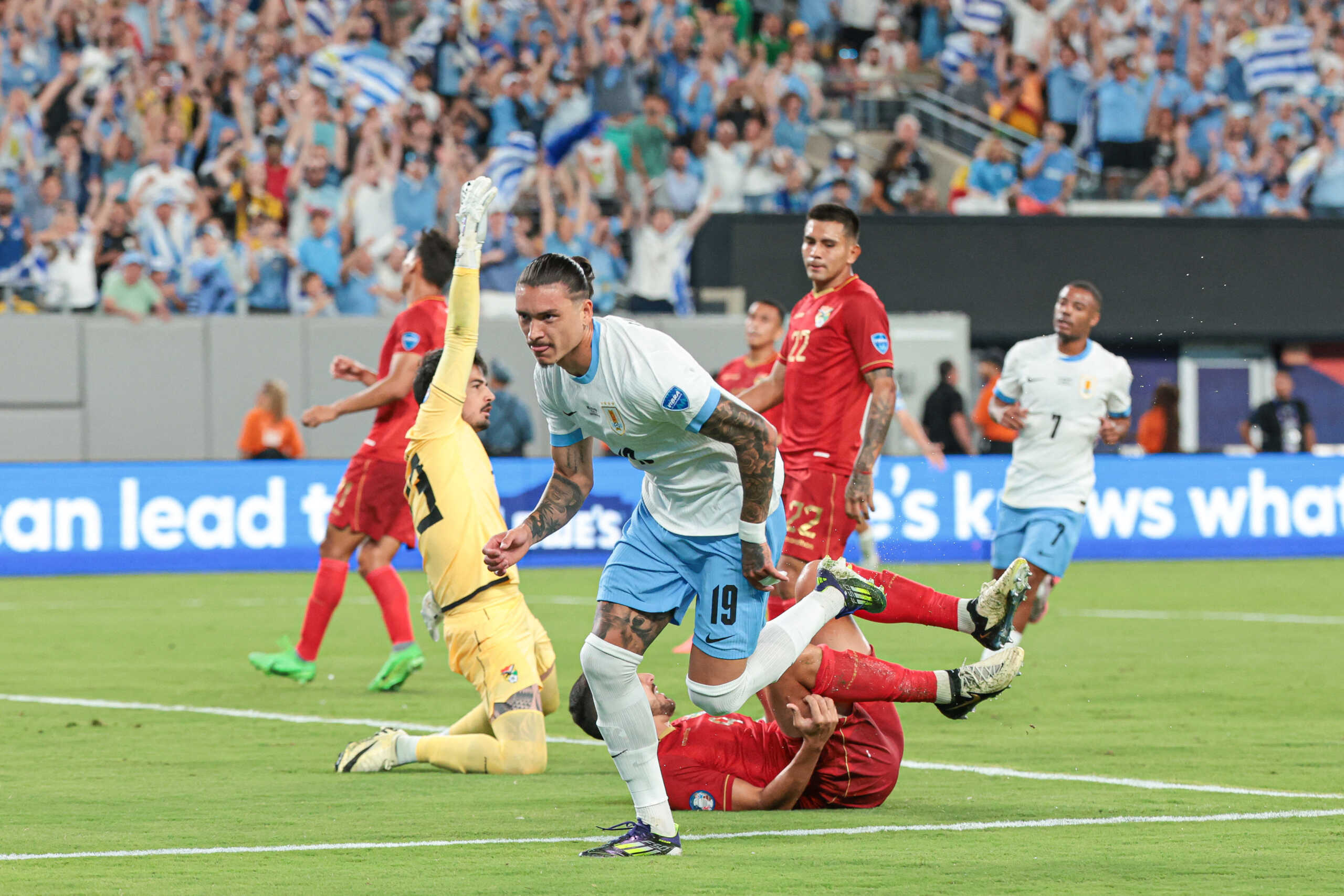 Jun 27, 2024; East Rutherford, NJ, USA; Uruguay forward Darwin Nunez (19) scores a goal past Bolivia goalkeeper Guillermo Viscarra (23) as defender Luis Haquin (4) defends during the first half of the Copa America match at MetLife Stadium. Mandatory Credit: Vincent Carchietta-USA TODAY Sports
