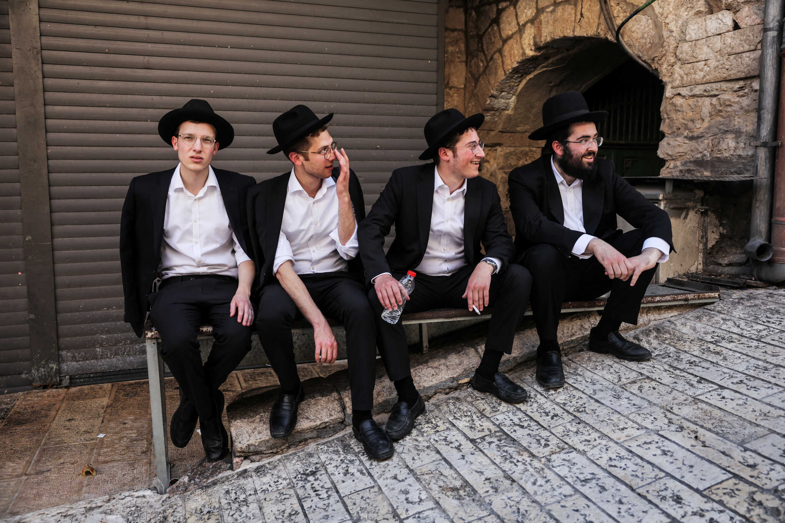 Ultra-Orthodox Jewish men sit in a street during the annual Jerusalem Day march, amid the ongoing conflict in Gaza between Israel and Hamas, in Jerusalem's Old City, June 5, 2024. REUTERS
