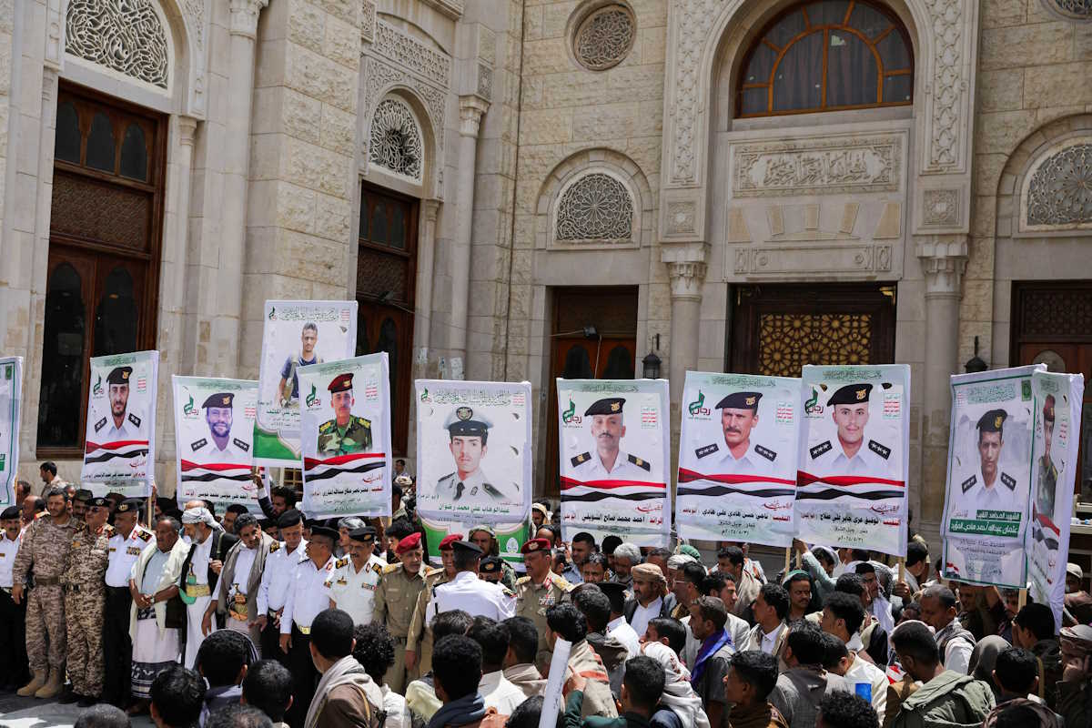 Mourners carry posters of navy officers killed in the recent U.S.-UK strikes, during their funeral in Sanaa, Yemen June 3, 2024. REUTERS